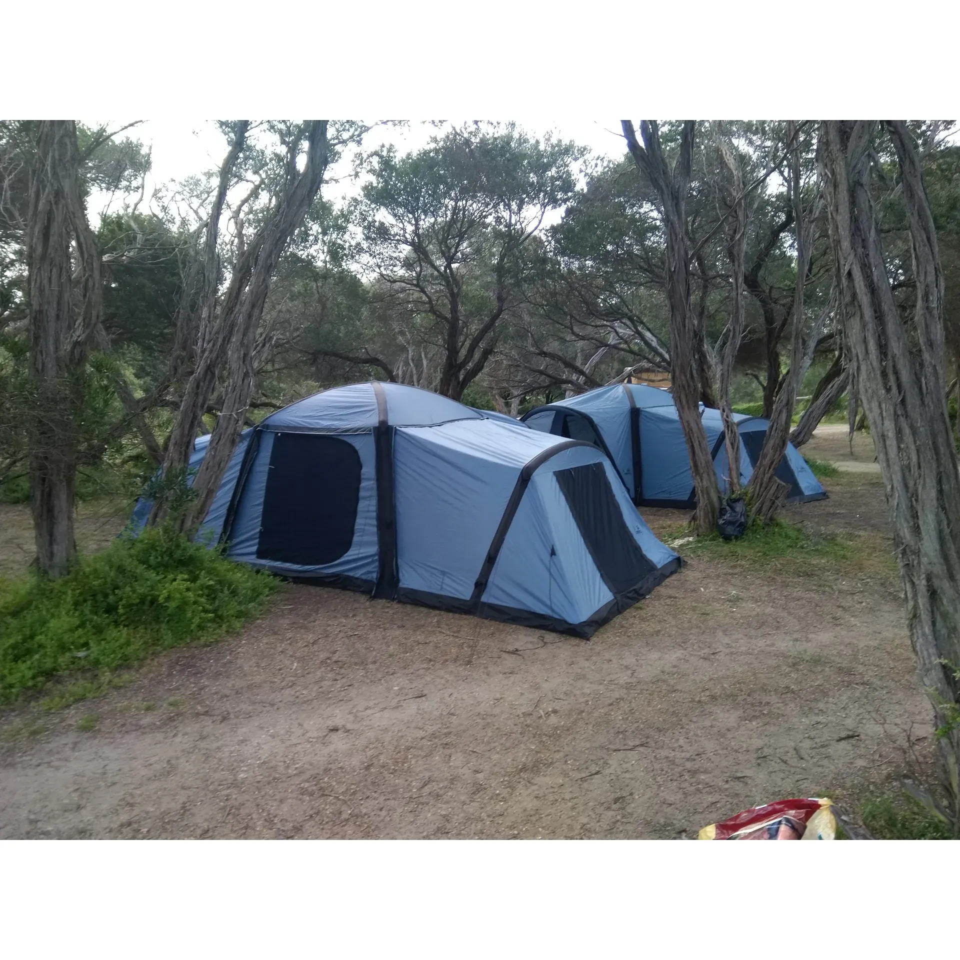 Campsite 18 is increasingly becoming a haven for camping enthusiasts seeking a serene getaway and an authentic outdoor experience. The landscape has undergone a beautiful transformation, with flourishing grass providing a verdant canvas for campers to set up their tents and relax in the embrace of nature. 

With newly installed steel ring fire pits at each campsite, Campsite 18 has shown commitment to sustainability and safety, ensuring that campfires are contained in a responsible manner while enhancing the camping experience. These fire pits are a recent addition that has greatly improved the environmental footprint of camping in the area, though campers are reminded to bring their own firewood to fuel their cozy campfires under the stars.

Designed for well-equipped adventurers, each campsite comes with the essential amenities that preserve the rustic charm of camping. Although the site employs a simple drop toilet facility and does not provide fresh water supply, the basic necessities are met for those prepared with their own provisions and resources.

Campsite 18 boasts easy beach access, providing a tranquil escape and fantastic fishing spots for those looking to reel in their catch of the day. While the beach adds to the allure of this destination, its rugged nature calls for caution and it's primarily recommended for fishing rather than swimming, due to local water conditions.

The large, spacious campsites are ideal for groups seeking a communal experience or for individuals yearning for a peaceful retreat. Campers can find solace under the shade or shelter from the onshore winds, making their stay comfortable amidst the elements. Although the local wildlife like flies might be present, it does not detract from the overall joy and beauty of staying at Campsite 18.

Campsite 11 within this beautiful refuge offers a particular appeal for those traveling with larger trailers, providing ample space and accessibility. These sites are a testament to the thoughtfulness that has gone into creating a versatile camping ground that can accommodate various types of camping equipment and group sizes.

Campsite 18 invites you to immerse yourself in a restorative camping experience, surrounded by the gentleness of nature and the quiet company of fellow campers. Whether you’re lounging by your fire pit or discovering the nearby beach, this destination is conducive to making lasting memories with every visit. Description by ChatGPT.