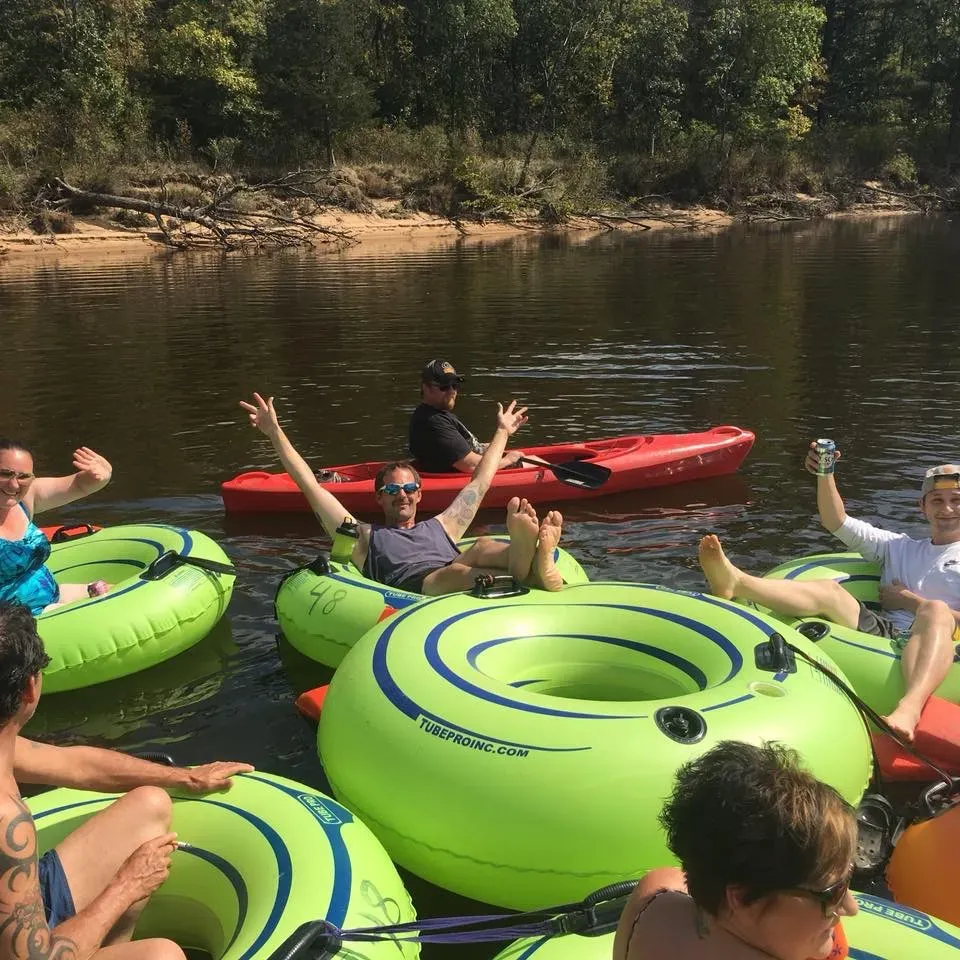 Discover the ultimate tubing escape at Point Bluff Tubing Resort, the quintessential destination for an exhilarating yet relaxing river adventure. A welcoming hub for families and friends alike, the resort has cultivated a vibrant and supportive atmosphere, where staff and visitors alike create a tight-knit, friendly community eager to assist with anything you may need.

Adventurous kids and adults can glide along the iconic Wisconsin River, basking in the joy of floating serenely in their individual tubes. The resort adds to the sense of ease and convenience by providing transportation upstream, allowing you to meander back to base at your own leisure.

At the heart of this enchanting resort are Fred and Julie, whose dedication to creating memorable experiences shines through in every aspect of your stay. Whether you're a seasonal camper or a weekend visitor, their commitment to service ensures your time at Point Bluff is nothing short of magical. Don't miss the chance to greet them during their regular walks through the campground—a personal touch that makes all the difference.

Unique safety features set the resort apart, with vigilant staff on jet skis patrolling the river to ensure a safe and pleasant journey for everyone. Their prompt assistance in guiding tubers away from shallow sand bars and maintaining the flow of the river adds an extra layer of care to your relaxing drift down the river.

Moreover, the Point Bluff Resort has thoughtfully provided straps to keep groups together— a simple, yet superior solution to keeping friends and families connected without the need for tying tubes together. This attention to detail enhances the overall experience, allowing you to focus on enjoying the beautiful scenery and each other's company.

Celebrated as the best place for tubing on the WI River, the resort's sterling reputation is further cemented by its exceptional staff who go above and beyond. Whether helping to retrieve lost items or ensuring the tubing process runs smoothly, their efforts contribute to the efficiency and pleasure of each visit.

Look forward to making unforgettable memories as you plan your next trip to Point Bluff Tubing Resort, a place where friendship, fun, and the free-flowing river come together for the perfect blend of excitement and relaxation. Description by ChatGPT.