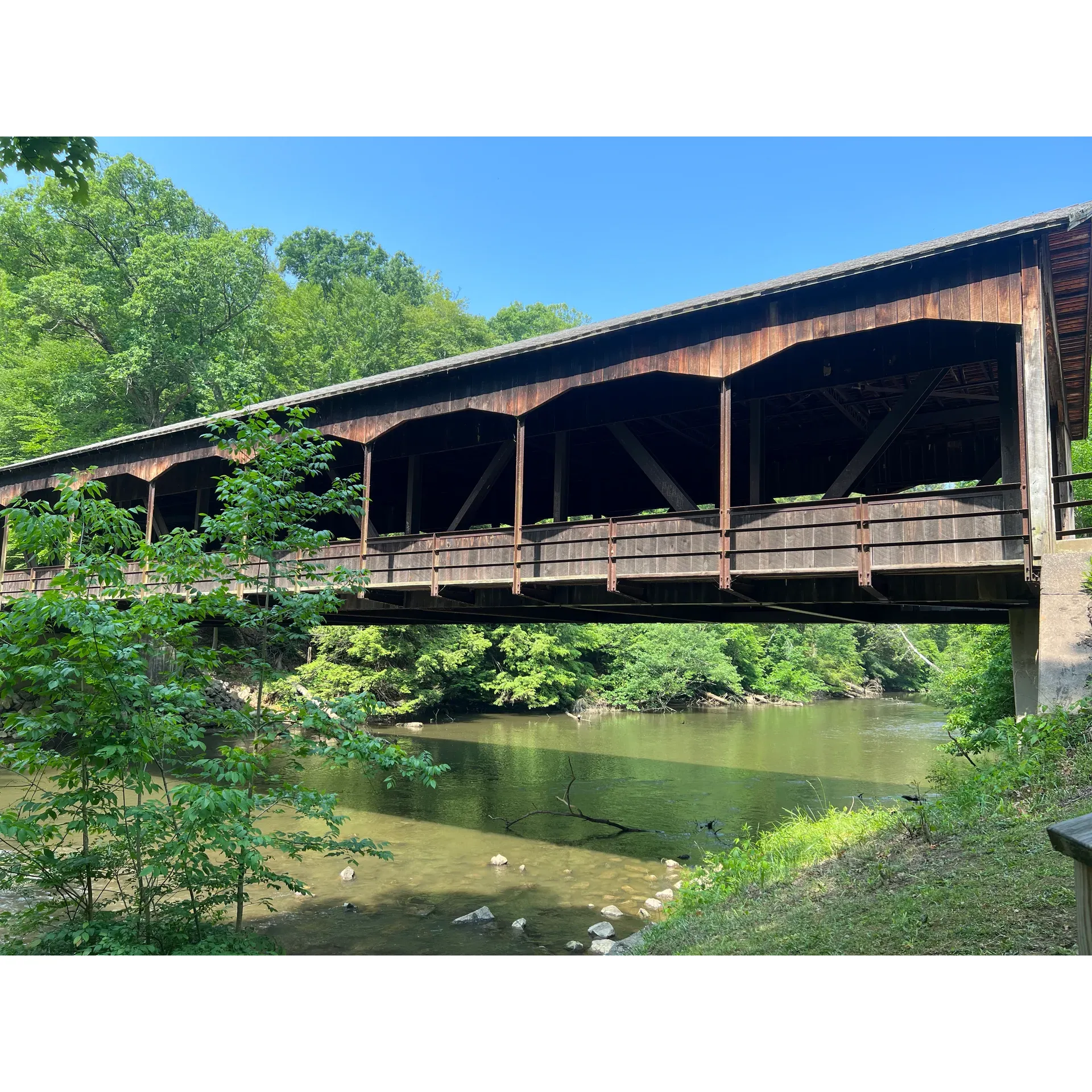 Immerse yourself in the quiet splendor of Mohican State Park, where the majesty of Ohio's natural landscapes unfolds before your eyes. Guests are continually charmed by the park's robust cleanliness and scenic beauty, which is diligently maintained to ensure a pristine environment for all to enjoy. Visitor experiences are enriched by the warmth and assistance provided by an ever-accommodating staff, ready to guide you towards the park highlights and share their knowledge of the area.

The park boasts an array of well-maintained trails that beckon hikers and outdoor enthusiasts alike. Whether you're seeking a tranquil walk through the woods or a more vigorous trek, the trails are designed to cater to a variety of preferences, ensuring a satisfying outdoor adventure for everyone.

For those who wish to extend their stay, the campground presents a peaceful retreat, characterized by its clean and serene surroundings. The well-stocked camp store is a testament to the park's commitment to convenience, offering a range of essentials and providing invaluable advice on exploring the local treasures.

One of the park's picturesque landmarks, the covered bridge, provides a charming backdrop for visitors looking to capture memories of their trip. While appreciating the journey is as delightful as the destination, the surrounding landscape beckons further exploration, with the dam and lake areas serving as idyllic spots for relaxation or observing the serene aquatic life.

Cabins within the park provide a cozy and comfortable respite, complete with modern amenities to make your stay enjoyable. The cabins are surprisingly spacious and designed to facilitate a quiet, intimate experience amidst nature. Nearby playgrounds and low-traffic areas ensure that peace and tranquility are preserved throughout your visit.

Hikers and nature enthusiasts will find the variety of terrain both stimulating and accessible. Returning visitors frequently remark on the evergreen appeal of the park's forests, hills, and streams. With ample opportunities to observe the local wildlife and botany, don't forget to bring binoculars to enhance your visual experience of the diverse avian population and the scenic vistas that are a hallmark of the park.

Conveniently located between Cleveland and Columbus, Mohican State Park serves as a delightful haven that provides an easy escape from the bustling city life. It stands as a beacon of tranquility and outdoor recreation, delivering a bountiful and memorable experience for nature lovers and families alike, no matter the season. With its splendid natural offerings and welcoming atmosphere, Mohican State Park is a true gem that promises a rejuvenating and refreshing visit with every season's turn. Description by ChatGPT.