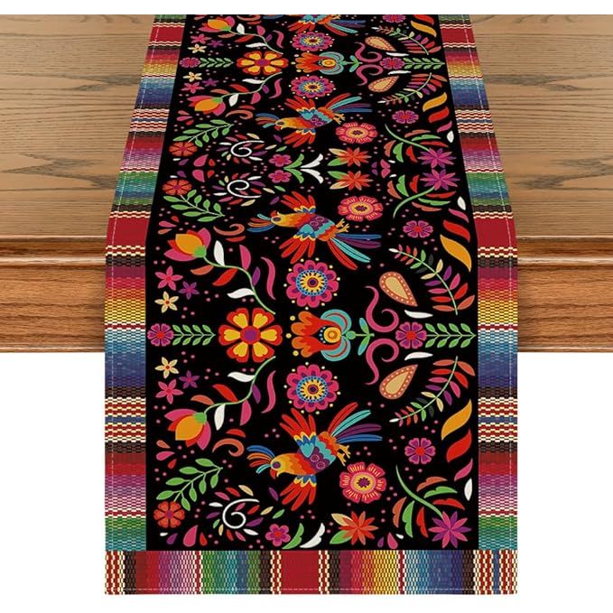 The Artoid Mode Bird Dia De Los Muertos Serape Mexican Fiesta Table Runner is a colorful and vibrant addition to any kitchen or dining room. Measuring 13x72 inches, this table runner is perfect for decorating your home for Cinco De Mayo or Day of The Dead celebrations.