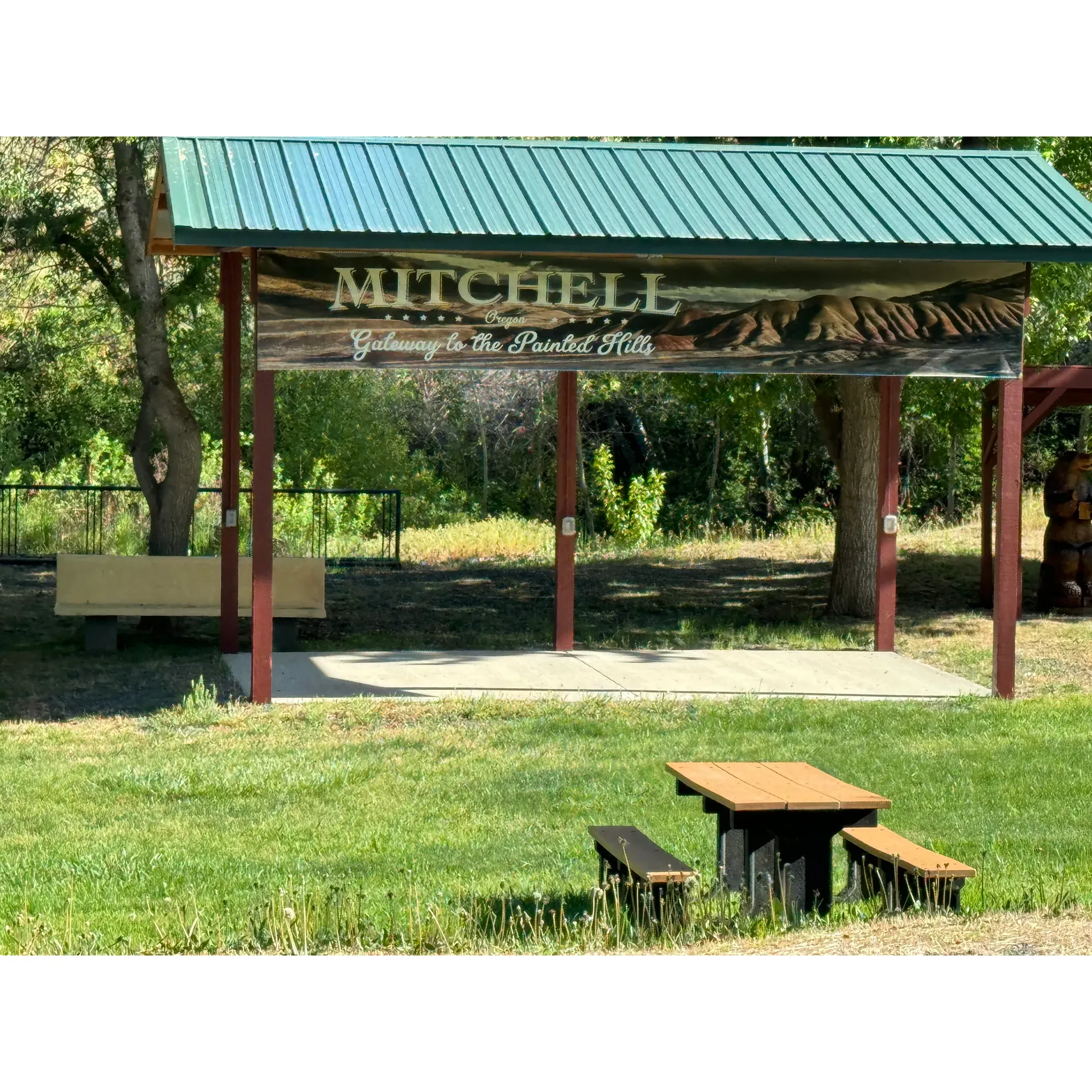 Mitchell City Park offers a charming and serene setting for visitors looking to explore the natural wonders of the nearby Painted Hills, a mere 15-minute journey away. With its picturesque backdrop and family-friendly environment, the park is an idyllic retreat where travelers can unwind under the canopy of a thoughtfully equipped playground tailored to entertain children of all ages. Adults and kids alike will be drawn to the tranquil flow of the small river that adds to the park's peaceful ambiance.

For those embarking on a cross-country adventure along Highway 26, the park provides a popular overnight haven, especially among cycling enthusiasts seeking a restful pitstop amidst their journey. The park's camping amenities cater to both tent and RV travelers, offering convenient access to clean water and 50 amp electricity to ensure a comfortable stay for all. With a capacity of just five spots, it offers an exclusive and intimate experience, prized for its quietude and well-kept grounds.

Adding to the charm of Mitchell City Park, the nearby restrooms are adorned with delightful murals that capture the spirit of the surrounding landscape. These facilities provide a quaint and novel touch that further enhances the visitor experience. The park's proximity to the local town allows for a leisurely stroll to discover a quaint restaurant housed within a residential setting, offering a unique dining adventure just blocks away.

Visitors are also afforded the simple pleasures of a picnic in the great outdoors, with the park boasting one covered picnic area, two additional picnic tables, and designated barbecue spots for a perfect family cookout. Well-positioned benches invite guests to sit and savor a moment of reflection, amidst the gentle hum of nature. And with public restrooms conveniently located just across the street, comfort and accessibility are assured.

Whether pausing for a moment to rejuvenate on a long drive or seeking a cozy camping spot for the night, Mitchell City Park provides a delightful blend of convenience, natural beauty, and small-town hospitality, crowned by the promise of connectivity with available 4G reception. All these attributes come together to create an enchanting park experience that leaves a lasting impression on all who visit. Description by ChatGPT.