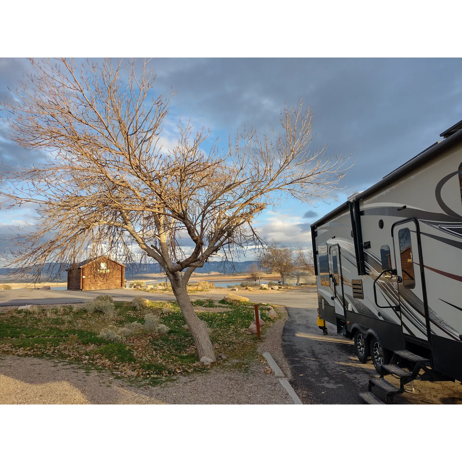 Oasis Campground offers an ideal outdoor retreat for nature enthusiasts and travelers alike, providing pristine and spacious accommodations for both tent camping and RV enthusiasts. With ample room for large vehicles, the park accommodates a seamless experience for those bringing RVs, including those with 35-ft fifth-wheels, thanks to the accessible pull-through spaces. 

Open to majestic vistas throughout the year, guests can enjoy the tranquility of the nearby lake, which is conveniently accessible with just a short walk, immersing visitors in the beauty of the surroundings irrespective of the season. For those who seek more permanent structures, the cabins at Oasis Campground receive high praise for their exceptional quality, offering a comfortable stay right by the water's edge.

The campground facilities underscore the comfort and convenience of all visitors. Exceptionally clean restrooms and on-site showers ensure that guests enjoy the comforts of home in the midst of the great outdoors. Well-maintained grounds offer designated camping sites and lush greenery, provided by nature's seasonality, contributing to an environment suitable for relaxation and recreation.

For those seeking aquatic adventures, the campground provides easy access to the lake and beach, whether on foot, by car, or by boat. The setting offers the perfect enclave for both tranquility and excitement; while there's a vibrant community atmosphere with fellow campers enjoying the area on four-wheelers and cherishing the panoramic views of the lake, quiet evenings are the norm, allowing for restful nights under the stars.

Catering to a range of preferences, the campground presents a family-friendly atmosphere where children and adults alike can revel in the outdoors. The weather here adds to the dynamic setting, presenting an ever-changing backdrop for your stay.

Oasis Campground strikes the perfect balance between nature's untamed beauty and the provision of amenities that ensure every visit is comfortable, enjoyable, and memorable. Description by ChatGPT.