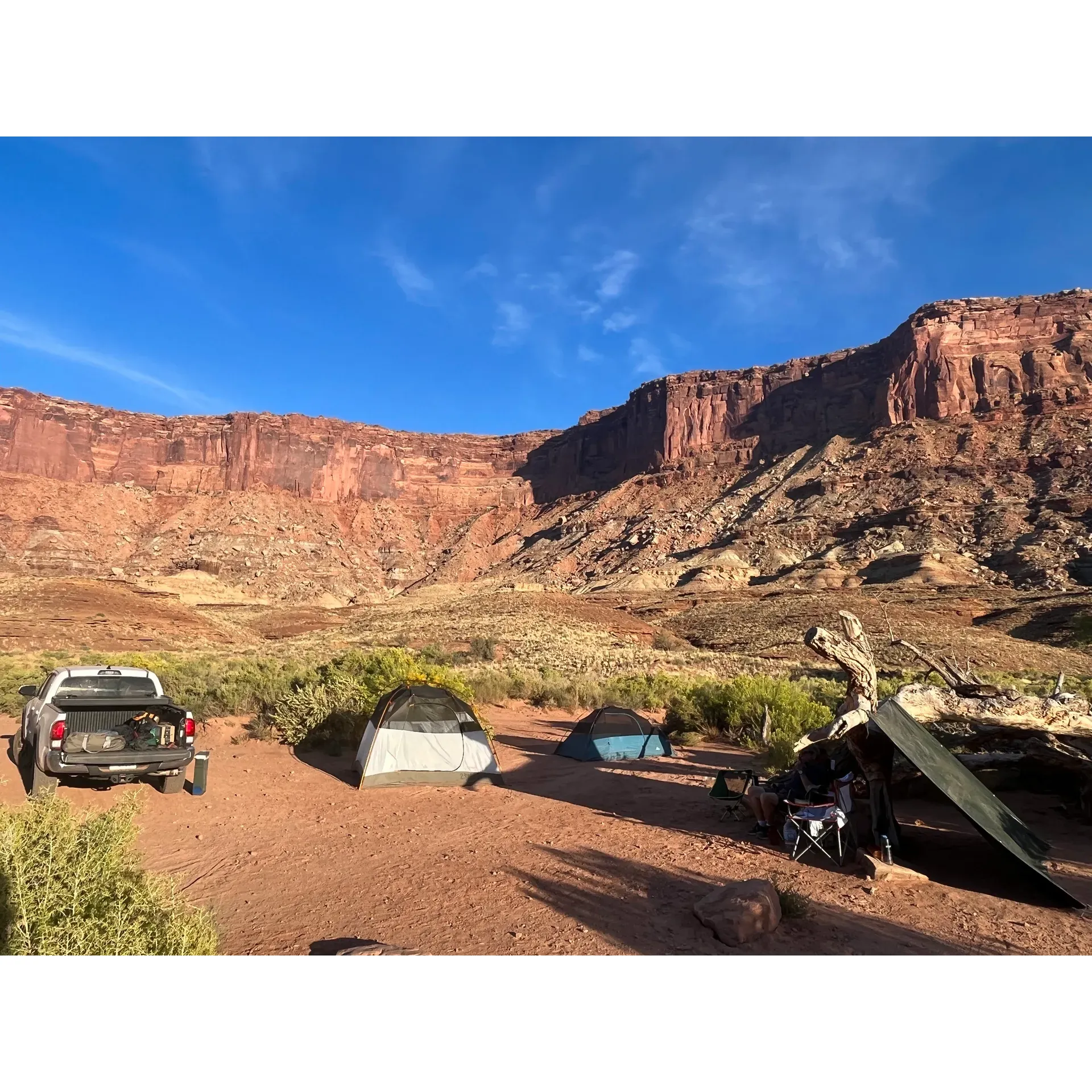 Hardscrabble Bottom Campground A offers the intrepid explorer a serene and authentic backcountry experience, ideal for those with a passion for solitude and the natural splendor of a remote wilderness. Immersed in an environment where the Milky Way paints the night sky with its celestial brush, this campground invites adventurers to a haven that rewards the challenges of the White Rim Road with breathtaking natural beauty.

Guests must prepare by securing a Backcountry Permit, encouraging thoughtful planning that ensures a personalized, crowd-free adventure. With a prime location just a mile from the engaging Fort Overlook hike — an experience enhanced with historic cabins and panoramic views of the river — this site serves as a perfect interlude for trekkers seeking a touch of exploration on their journey.

Offering more than just a patch of earth, Hardscrabble Bottom Campground A is equipped with an accessible outdoor toilet and is one of the rare spots amid the terrain to boast trees and greenery, creating a refreshing setting after a day of rugged travel. Wildlife enthusiasts may delight in the nocturnal ballet of bats that frequent the area, adding a mesmerizing aspect to the campground’s nocturnal ambiance. 

For those arriving by way of a four-wheeler, the campsite is a welcoming reprieve that is easily accessible without the need for a specially modified vehicle. Spacious and well-maintained, the campground allows for a comfortable outdoor living space where guests can recover and rejuvenate in preparation for the next day’s continuation along the breathtaking White Rim Trail.

Embracing the thrill of the great outdoors, Hardscrabble Bottom Campground A is a cherished stop for those who have ventured to its secluded charm, offering a unique story to every traveler brave enough to traverse its path. It is a destination that promises not just a space for respite, but a memorable chapter in the adventure of a lifetime. Description by ChatGPT.