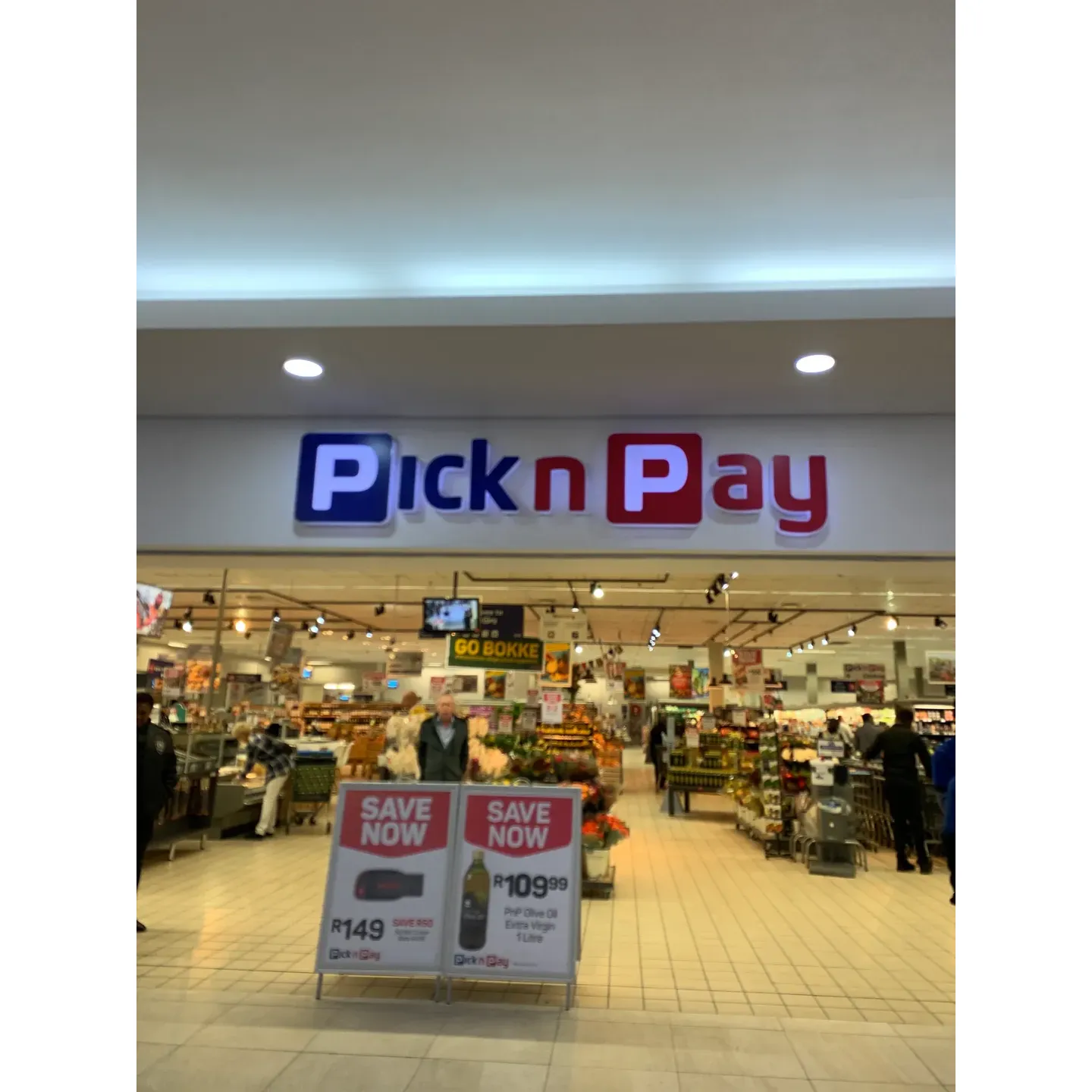 Pick n Pay Waterstone Village is a shining example of customer service excellence and retail innovation in the Western Cape. Under the leadership of Manager Bertie Carstens, this store has garnered admiration from its customers for its exceptional service standards. Patrons are greeted with genuine assistance from dedicated staff members like Gerswin Wagenaar, whose friendly demeanor and proactive approach to product search are frequently lauded by grateful shoppers.

A real treat for the senses, the store boasts a newly revamped layout that includes a tantalizing coffee bar to refresh and reinvigorate its clientele. The fresh produce section is a veritable garden of delight with its assortment of ripe fruits, vegetables, and even herbs growing on-site. Inventive product displays and spacious, navigable aisles make for a seamless shopping journey.

Technology complements the shopping experience with digital signage and interactive screens that offer wine and cheese pairing recommendations – a boon for connoisseurs and casual browsers alike. The wine selection is extensive and expertly curated to satisfy the palette of every wine lover.

The store's commitment to quality extends to their exclusive Pick and Pay Crafted Collection range, which boasts premium products that consistently impress with their excellent quality.

Customer feedback highlights the valued assistance provided by store employees such as Edward and Ntokeleng, whose helpful attitudes are a testament to the store's overall friendly and accommodating atmosphere.

Clean, thoughtfully organized, with special care taken even in the placement of essentials like pet food, Pick n Pay Waterstone Village excels in creating an inviting atmosphere where freshness and quality take center stage, ensuring that each shopper's experience is not just a transaction but a pleasant excursion into the world of refined shopping. Description by ChatGPT.