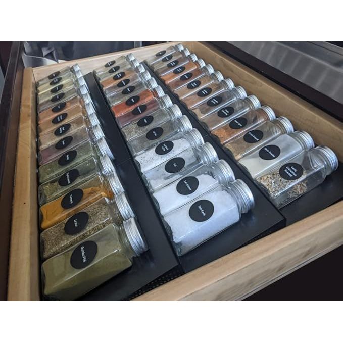 The Artibear Expandable Aluminum Spice Rack Drawer Organizer is a set of six tray organizers designed to fit kitchen cabinets with a width of 8 to 16 inches. Made of durable aluminum material, these organizers are built to last and can hold a variety of spices and small kitchen items.