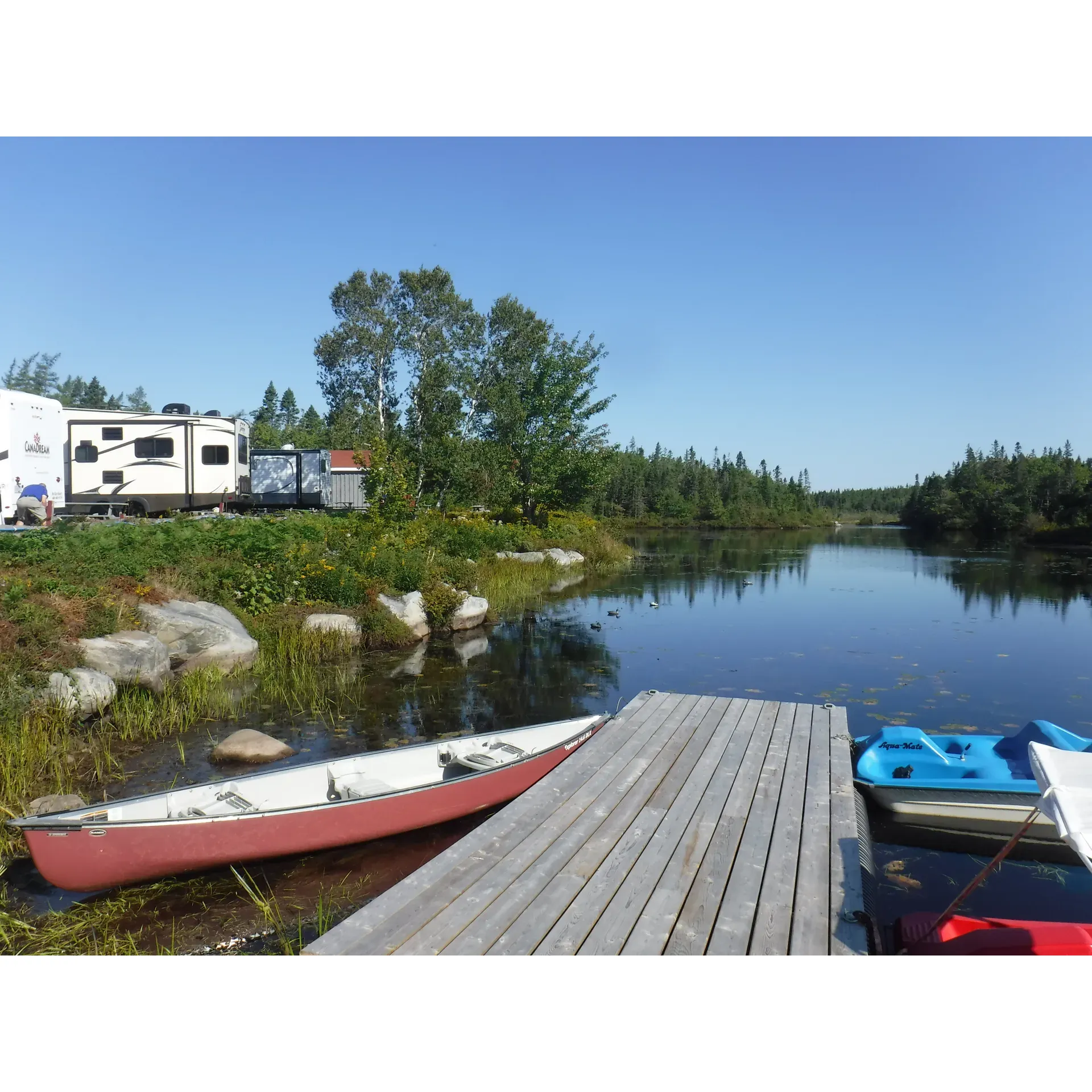 Lockeport Campground & Cottages is an idyllic retreat for those seeking a blend of outdoor adventure, relaxation, and a community vibe. The hospitality of owners Rudy and Susan shines through, as they extend a warm welcome to all guests, whether you're a seasoned camper or a newcomer to the world of trailers and RVs. Offering a variety of lots, from full-service to basic, the campground caters to a range of preferences and ensures that every stay is comfortable and convenient.

Visitors can look forward to well-maintained facilities, including spotless restrooms, showers, and a heated saltwater pool which remains open longer in the season. The property boasts a scenic backdrop with a serene lake and charming cottages dotting the landscape, creating a picturesque scene perfect for relaxation and making memories.

Lockeport is a paradise for children too. With amenities like a swimming pool, playground, playhouse, and the friendly presence of Susan and Rudy's dogs, young ones are sure to find endless entertainment and may even be a bit sad to leave these joyful surroundings. Adults and kids alike will appreciate the ample and private RV spots spread throughout the woods and the open areas, offering breathtaking views and personal space that is often lacking in more crowded campgrounds.

For those interested in exploring, beautiful beaches are within close proximity, while conveniences like a corner store are just a two-minute walk away. Lockeport offers both the tranquility of the countryside and the accessibility of nearby amenities, ensuring that guests have everything they need right at their fingertips.

The campground embodies a dedication to a green lifestyle with an easy recycling setup, catering to ecologically conscious visitors. Bearing the hallmark of thoughtful stewardship, Susan and Rudy provide not just a place to stay but a truly supportive community experience. They are even known to go the extra mile, from assisting with RV repairs to arranging fresh local lobster for guests to enjoy.

Lockeport Campground & Cottages is a hidden gem where the natural beauty of the area combines with unparalleled hospitality, making every stay memorable. It's a top recommendation for anyone seeking a hospitable, picturesque, and relaxing getaway with plenty to do and explore in the surrounding region. Description by ChatGPT.