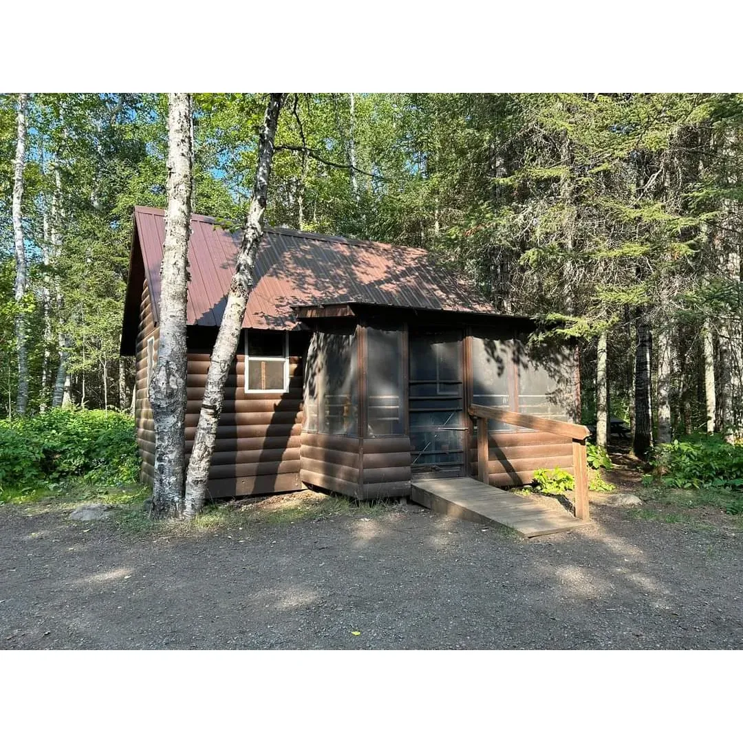 East Bearskin Lake Campground emerges as an idyllic retreat for outdoor enthusiasts looking to immerse themselves in the serenity of nature. This tranquil oasis offers a unique blend of seclusion and accessibility, with each campsite thoughtfully positioned to provide an intimate experience while still maintaining a sense of community. Guests frequently commend the setting for its supreme tranquility, which allows the sounds of nature to be the soundtrack of their stay.

Adventure seekers will appreciate the campground's proximity to a myriad of interconnected lakes, including the serene waters that lead to the enchanting Crocodile Falls. The lake access, though quaint, is lauded for its suitability for a variety of watercraft, making it a favored spot for those eager to explore by canoe, kayak, or paddleboard.

The sites themselves are characterized by their rugged charm, offering a blend of rocky terrain and grassy patches where visitors can comfortably set up their tents. Picnic tables and well-maintained fire pits add to the convenience and enjoyment of each site, complemented by their affordability which is particularly appreciated by cost-conscious travelers.

Visitors are also drawn to the charming cabin options within the campground, with specific recommendations for the Alder Cabin due to its ample outdoor space and accessibility to the lake. For those seeking additional privacy and ease of water access, the Alder Cabin stands out as an optimal choice, while the Aspen Cabin intrigues with its cozy screened-in porch and loft sleeping area, despite its more compact outdoor presence.

Families and nature lovers revel in the campground's offerings, which include open spaces for children and pets to play and explore, fostering imagination and a sense of freedom. The area provides a clear, star-filled sky that dazzles guests nightly, and the proximity to Bearskin Lodge allows for additional recreational options like dog-friendly pontoon rentals for a leisurely cruise on the lake.

The atmosphere at East Bearskin Lake Campground is consistently described as respectful and courteous, with fellow campers mindful of noise, ensuring a peaceful and relaxing experience. Given the campground's proximity to nature's bounty and the array of amenities that cater to both relaxation and adventure, it serves as an ideal getaway for those seeking to forge unforgettable memories in the great outdoors. Description by ChatGPT.