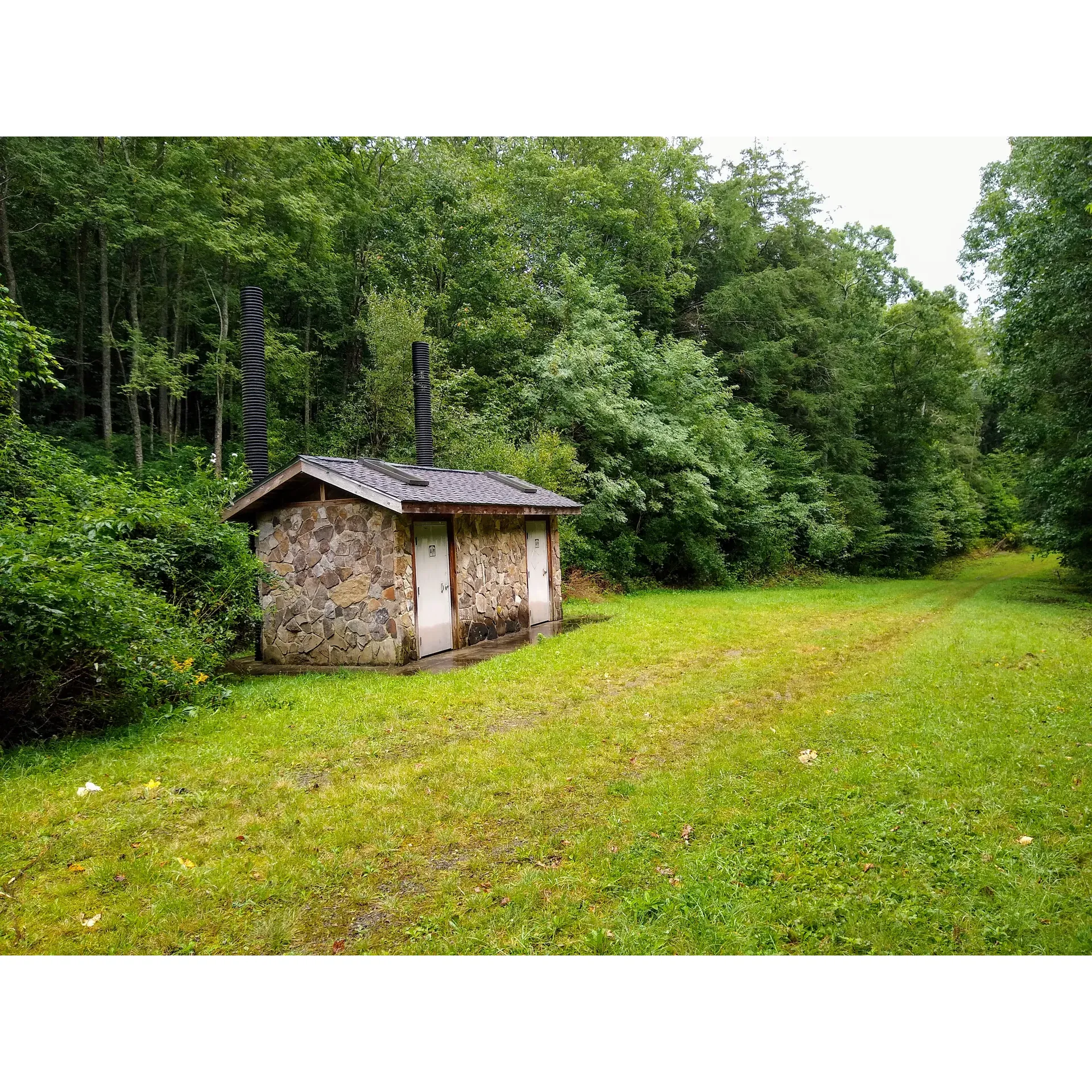 Wine Spring Horse Camp offers an authentic back-to-nature experience surrounded by the serene beauty of a remote, mountainous setting. This quaint and scenic horse camp is an ideal retreat for equestrian enthusiasts and outdoor lovers alike, providing a peaceful sanctuary only 20 miles from the vibrant landscapes of Western North Carolina. Each campsite is thoughtfully equipped with grill/fire pits and picnic tables, ensuring a comfortable stay, while the flat terrain accommodates both tents and small trailers with ease, including convenient pull-through sites for hassle-free setup.

Campers can relish the tranquility that comes with the camp's seclusion, where the bustling sounds of everyday life are replaced with the whispers of the forest. With a paved forest service road only a short distance away, access to the camp remains unintrusive, preserving the quiet atmosphere. The site boasts a pit toilet facility for added convenience, maintaining the rustic charm of the campgrounds.

Reservation is a breeze, requiring just a simple call to the Forest Service to secure a spot at an affordable rate, complete with the necessary information for gate access. Once settled, guests can explore numerous trails perfect for horseback riding adventures, with the camp's five available spaces offering ample room for horse trailers and the animals themselves. Though the water sources are sparse, the camp's pristine natural environment and the stunning display of Autumn colors make for an unforgettable visit, especially for those fortuned with a stay during the striking season. Whether seeking a solitary getaway or a riding expedition through the ever-changing foliage, Wine Spring Horse Camp is a picturesque escape that captures the heart of Western North Carolina’s wilderness charm. Description by ChatGPT.