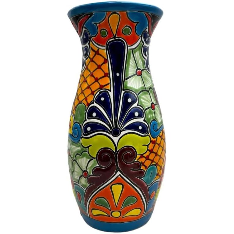 The Talavera Tall Vase Pot is a hand-painted Mexican pottery piece that can be used both indoors and outdoors as a vibrant home decor accent. Measuring 13.75 inches tall, this multicolored vase features traditional folk art designs that are characteristic of Talavera pottery, known for its intricate detailing and bright colors.