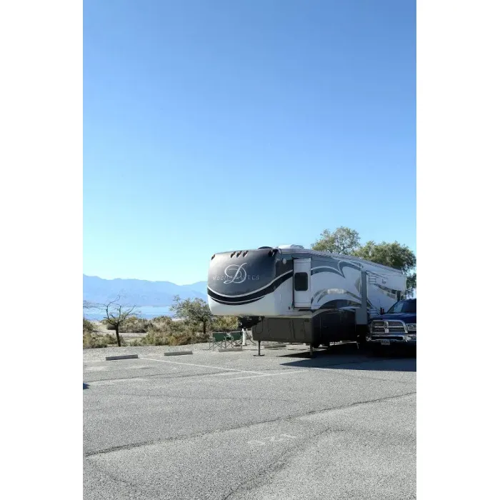 Situated along the tranquil shores of Salton Sea, Mecca Beach Campground offers a serene retreat for nature enthusiasts and campers seeking a peaceful escape. With its spacious sites, visitors are afforded ample room to spread out, whether setting up a tent or parking an RV. The spectacular views of the surrounding mountain range complement the breathtaking vistas across the Salton Sea, providing a picturesque backdrop to every activity.

The campground prides itself on maintaining impeccable facilities, with visitors consistently commending the cleanliness of both the bathrooms and showers. Such attention to detail ensures a comfortable and refreshing stay for all guests.

Guests can enjoy the invigorating fresh air carried by the pleasant westerly breeze, often accompanied by the harmonious absence of any unpleasant odors, contributing to the refreshing ambiance of the campground. Additionally, the Mecca Beach Campground is fortunate to have a congenial camp host who greets newcomers with warmth and is eager to make their stay enjoyable.

For those interested in the area's history, the nearby Visitor Center is a treasure trove of information, featuring a small museum that eloquently tells the story of the Salton Sea's wildlife, environment, and past events. It's an insightful experience that enhances the appreciation for this unique landscape.

Stargazers will revel in the clear desert skies, where celestial wonders such as Mars, Jupiter, and Venus make vivid appearances against the night's canvas. The quietude of the campground only amplifies this stellar show, making for an unforgettable evening under the stars.

Visitors to Mecca Beach Campground praise the undisturbed atmosphere, where one can find moments of stillness under the shade of a wispy smoke tree, gazing out over the sea's reflective waters. It's a place that invites both relaxation and exploration, where time seems to stand still, providing a rare opportunity to disconnect from the bustle of daily life and reconnect with the natural world.

Whether arriving for a night of stargazing, a day of adventure in the vast desert surroundings, or simply seeking a space for quiet contemplation, Mecca Beach Campground stands out as a pristine destination for those who cherish the great outdoors. Description by ChatGPT.