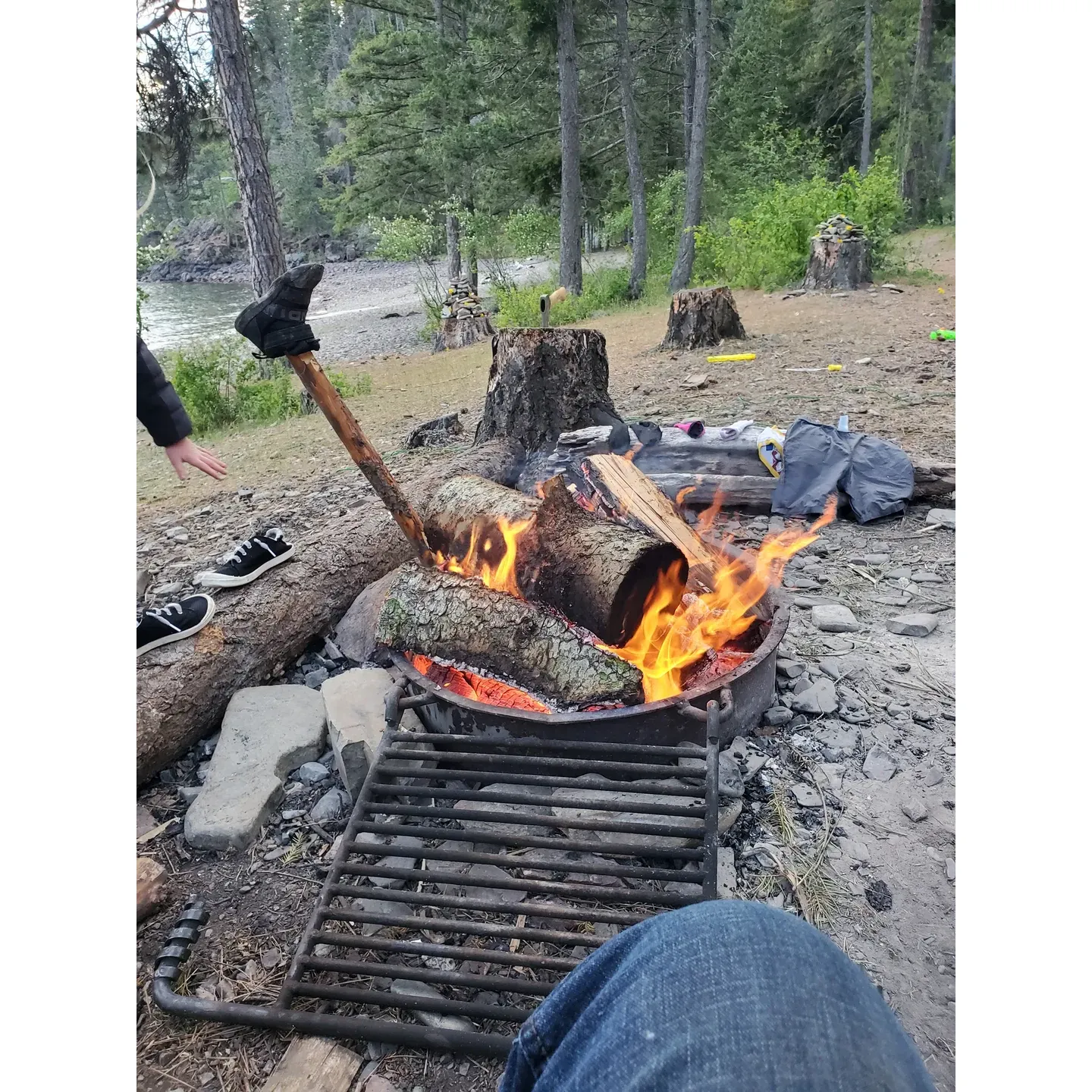 Green Bay Campground Beach is a true gem for campers and outdoor enthusiasts. Its breathtaking beauty captivates visitors, making it a favored destination for those seeking a tranquil retreat in a picturesque setting. The campgrounds, just a short stroll from the parking area, offer an intimate connection with nature coupled with the convenience of on-site composting toilets, enhancing the rustic experience while maintaining environmental consciousness.

Popular among families and long-time visitors, the sites offer stunning views that can be enjoyed from the comfort of your tent or while engaging in a variety of outdoor activities. The region is a haven for hikers, boasting a range of trails suited to all levels, ensuring an invigorating experience for both novices and experienced adventurers. For those drawn to the water, the campground is a paradise; kayaking and paddleboarding reveal a different perspective of the magnificent surroundings. Anglers find solace in the bountiful fishing, while swimmers revel in the surprisingly warm waters of the lake, its clarity and cleanliness inviting a refreshing dip.

The community here is characterized by a respectful and family-friendly atmosphere, with quiet hours observed, ensuring peaceful nights under the stars. The spirit of inclusivity extends to four-legged friends, with the campground being a welcoming space for pets to enjoy the great outdoors alongside their owners.

The camping experience is further enhanced by thoughtfully designed campsites, some of which boast direct proximity to the water for an immersive lakeside experience. Each site is equipped with a designated campfire pit complete with a cooking grate, perfect for preparing meals and enjoying the crackling warmth of a campfire.

Green Bay's proximity to local amenities offers convenience without compromising the remote feel, allowing for easy resupply runs without detracting from the serenity of the woodland escape. While the terrain may challenge tent setup with its rocky ground, the extra effort pays off, rewarding campers with an authentic and memorable outdoor living experience.

For those seeking a dash of adventure mixed with serene beauty, the camp's nearby cliffs provide an adrenaline rush for cliff jumpers, adding an element of excitement to the peaceful surroundings.

All in all, Green Bay Campground Beach is a sanctuary where memories are made, friendships are formed, and the beauty of nature is celebrated in every sunrise, mountain trail, and ripple on the lake. Description by ChatGPT.