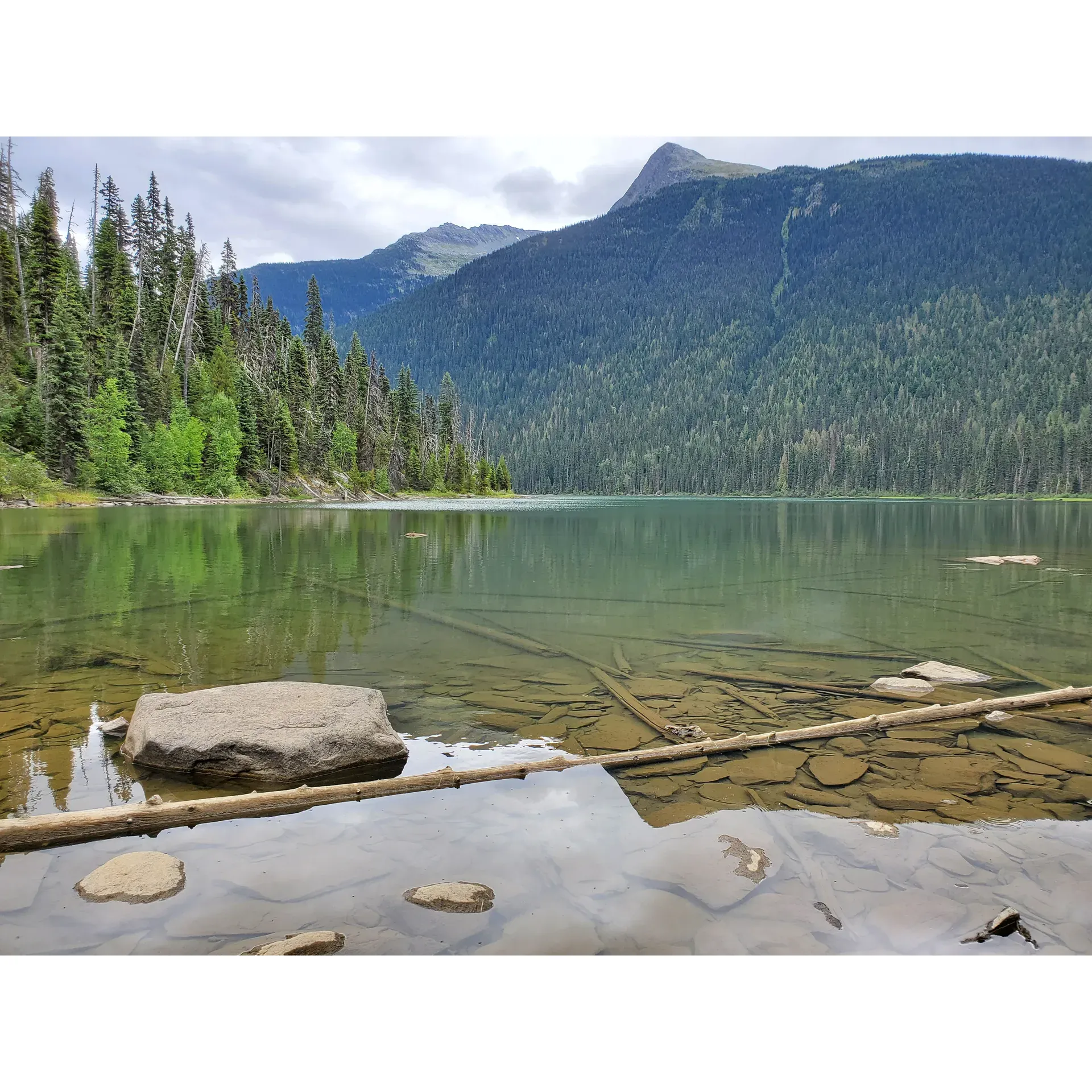 Ghost Lake Recreation Site offers visitors a serene escape into the splendor of natural landscapes. Renowned for its picturesque setting, it provides a tranquil retreat where the beauty of the surrounding environment captivates every onlooker. This destination is a paradise for photographers, with ample opportunity to capture stunning vistas, whether on land or from above with the aid of a drone, ensuring that every snapshot is postcard-worthy.

Visitors are treated to a scenic drive that leads to Ghost Lake, where breathtaking views unfold along the route, offering several inviting spots to pause and soak in the picturesque surroundings. The journey itself becomes an integral part of the experience, with the drive highlighted as a memorable adventure.

Families find this the perfect spot for bonding and creating lasting memories together, with nature's majesty as their backdrop. The area boasts a quaint yet appealing campsite, offering a cozy retreat for anyone looking to immerse themselves in the great outdoors. While the site comfortably accommodates those who prefer a more rustic camping experience, it provides the essentials for a comfortable stay.

The allure of Ghost Lake extends beyond just its visual charm, ensuring that every visit is an enchanting encounter with nature's serene and untouched beauty. Whether seeking a peaceful getaway or an idyllic setting for family fun, Ghost Lake Recreation Site stands out as a cherished destination for all who appreciate the great outdoors. Description by ChatGPT.