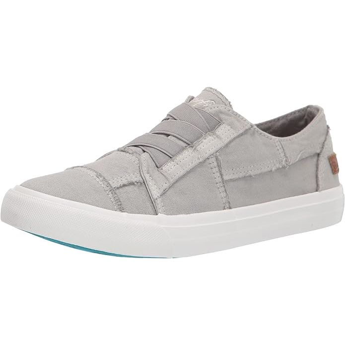 The Blowfish Women's Marley Slip-On Sneaker is a casual and stylish footwear option for women. It features a canvas upper with distressed edges for a worn-in look, adding a touch of rugged charm to any outfit. The slip-on design makes for easy on and off, while the elastic goring on the sides offers a flexible and comfortable fit.