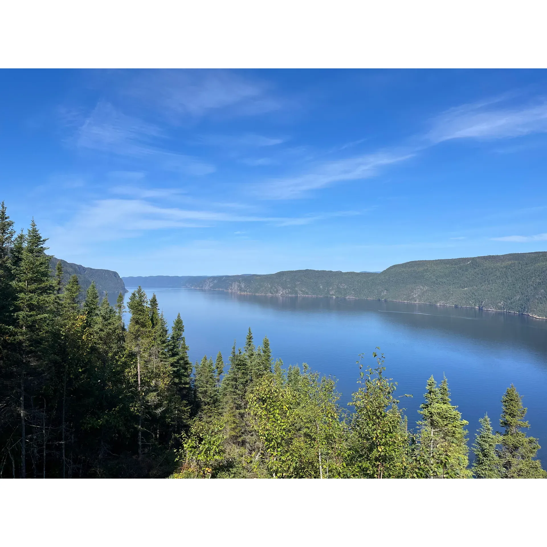 L'Anse De Tabatière offers an unparalleled opportunity to experience the grandeur of the Saguenay fjord with convenience and breathtaking views. Ideal for visitors who prefer to minimize hiking while maximizing scenery, this destination invites travelers to immerse themselves in the natural beauty of the fjord, all within a mere hour’s drive from Saguenay. 

Visitors are greeted with a choice of several scenic lookout decks that are easily accessible, with just a short 0.5 km stroll from the ample parking area. With such proximity to the fjord's impressive landscape, the location is celebrated for providing a superior vantage point over the Le Fjord du Saguenay Discovery and Visitors Centre, as recommended by many who have enjoyed the stunning views.

The facility is thoughtfully equipped with clean restrooms, adding comfort to your visit. Furthermore, free telescope binoculars are available on-site, allowing guests to peer into the distance and perhaps catch a glimpse of the fjord's vastness, even when the weather does not fully cooperate.

Those passionate about autumn colors will be delighted by the fall views, which are often described as nothing short of stunning. And for those who delight in the magic of dusk, the sunset views from L'Anse De Tabatière are simply spectacular, creating a celestial ambiance that is both serene and spellbinding. Visitors are encouraged to arrive early, especially during long weekends, to secure a spot at one of the picnic tables. 

Apart from the visual feast, L'Anse De Tabatière offers guests a sense of connection with the region’s history, enriching the visit with a deeper understanding of this unique landscape. Though there is an admission fee, many find the experience to be well worth the investment, given the priceless memories made while soaking in the grandeur of Saguenay's majestic fjord. Description by ChatGPT.