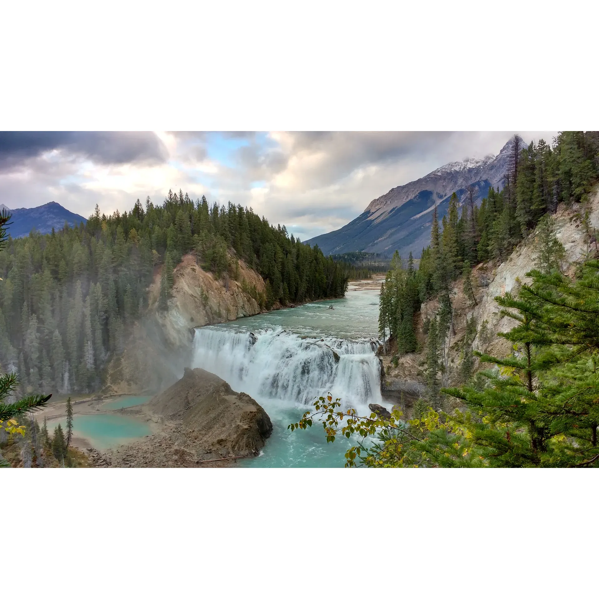 Wapta Falls Recreation Site offers an exceptional outdoor experience for nature lovers and adventure seekers alike. Its prime location affords visitors stunning views of the majestic Wapta Falls from the southern vantage point, creating a perfect backdrop for breathtaking photography. The area is accessible through a short hike that is even pet-friendly, allowing you to share the beauty of the falls with your furry companions.

Guests who spend a couple of days at the site can immerse themselves in a serene, no-cost wilderness retreat. With plenty of visitors passing through, it's a haven for social butterflies who enjoy meeting diverse people from around the globe. Those preferring solitude can still find their peace, as the site remains a tranquil getaway.

Timing is everything when visiting the falls; an early evening excursion rewards with sunlight casting a glorious glow on the cascade, while sunset paints the surrounding mountains in spectacular colors. The Recreation Site embodies the true spirit of British Columbia's natural offerings, emphasizing a "leave no trace" philosophy that encourages respect and preservation for nature.

Nearby Fraser Creek, just 2 kilometers away, provides a crystal-clear water source, though it is always advisable to filter water in the wilderness. Moreover, those with a taste for connectivity will appreciate the strong cell service available at the site.

The Falls themselves are a sight to behold, impressing even from a distance, ensuring that those with young children or visitors not inclined to hike closer can still enjoy their grandeur comfortably.

Adventurers seeking an off-road journey will find the seclusion they crave along the peaceful, less-traveled roads leading to Wapta Falls. With the cascades framed by the towering mountains, the panorama is nothing short of awe-inspiring.

Navigating to the site offers its own adventure. Be mindful when using navigation aids as deviations may be necessary – a small journey of discovery that leads to an unforgettable destination in the heart of the wilderness, just a detour away from the route to Banff.

In summary, Wapta Falls Recreation Site is the perfect mix of accessibility and wilderness charm, offering a marvelous natural setting that's great for a day's exploration or a multi-day camping experience, welcoming everyone from families to solo travelers looking to connect with nature's splendor. Description by ChatGPT.