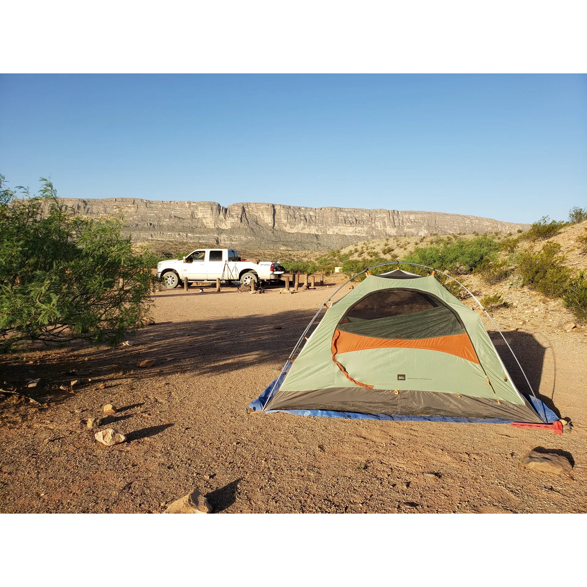 Terlingua Abajo offers an exquisite outdoor experience with breathtaking views of the legendary Santa Elena Canyon, providing an idyllic backdrop for your camping adventure. Immersed in the beauty of its surroundings, the campsite presents a wonderful opportunity for exploration, where hikers can meander through creek areas and stumble upon historical ruins, adding a touch of mystery and wonder to their journey.

The carefully chosen campsite locations are set to ensure that each morning greets campers with an awe-inspiring panorama as sunlight bathes the canyon walls. Although the access road is well-maintained, it's advised to be vigilant during rainy conditions. Comfortably accommodating two vehicles per campsite, parking is thoughtfully arranged to balance convenience with the spaciousness of the campgrounds. Moreover, the arrangement suggests an ideal solution for larger groups if all three sites are reserved, creating a close-knit yet private outdoor gathering space.

Wildlife sightings, such as coyote and javalina, enrich the authenticity of the camping experience. To maintain the pristine condition of the area and ensure safety, a bear box is available for food and trash storage. Enjoyment here extends from dawn to dusk, with the dramatic spectacle of sunrise and the chance to indulge in unparalleled stargazing under the dark, clear night sky.

It's important to note that amenities such as restrooms, power, and wood fires are not available, preserving the natural integrity of the environment and encouraging a more genuine rough-it-style camping trip. The site's peaceful ambiance is complemented by the friendly, professional assistance provided by the owner, ensuring all adventurers' needs are catered to, from car and truck issues to RV mishaps, guaranteeing peace of mind throughout the wilderness escape.

Terlingua Abajo is a serene retreat, promising a camping experience that celebrates magnificent vistas, historical intrigue, and the natural harmony of the Texan desert landscape. Whether you're seeking solitary tranquility or a memorable group expedition, this destination delivers an unforgettable outdoor sojourn. Description by ChatGPT.