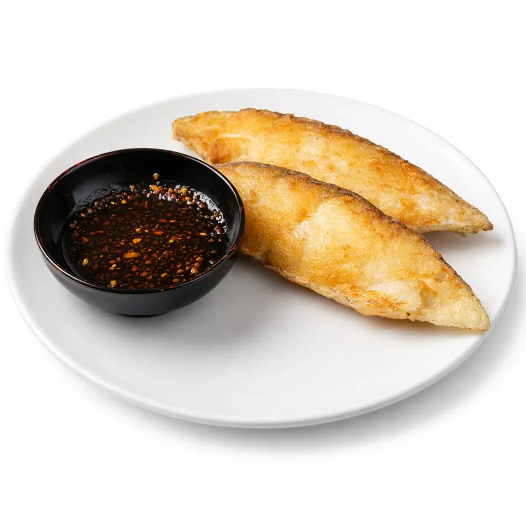 A delightful East Asian-inspired dish featuring tender halibut fillets wrapped in a crispy coating and served with a ginger-infused sauce, perfect for those who enjoy a balance of texture and flavor.