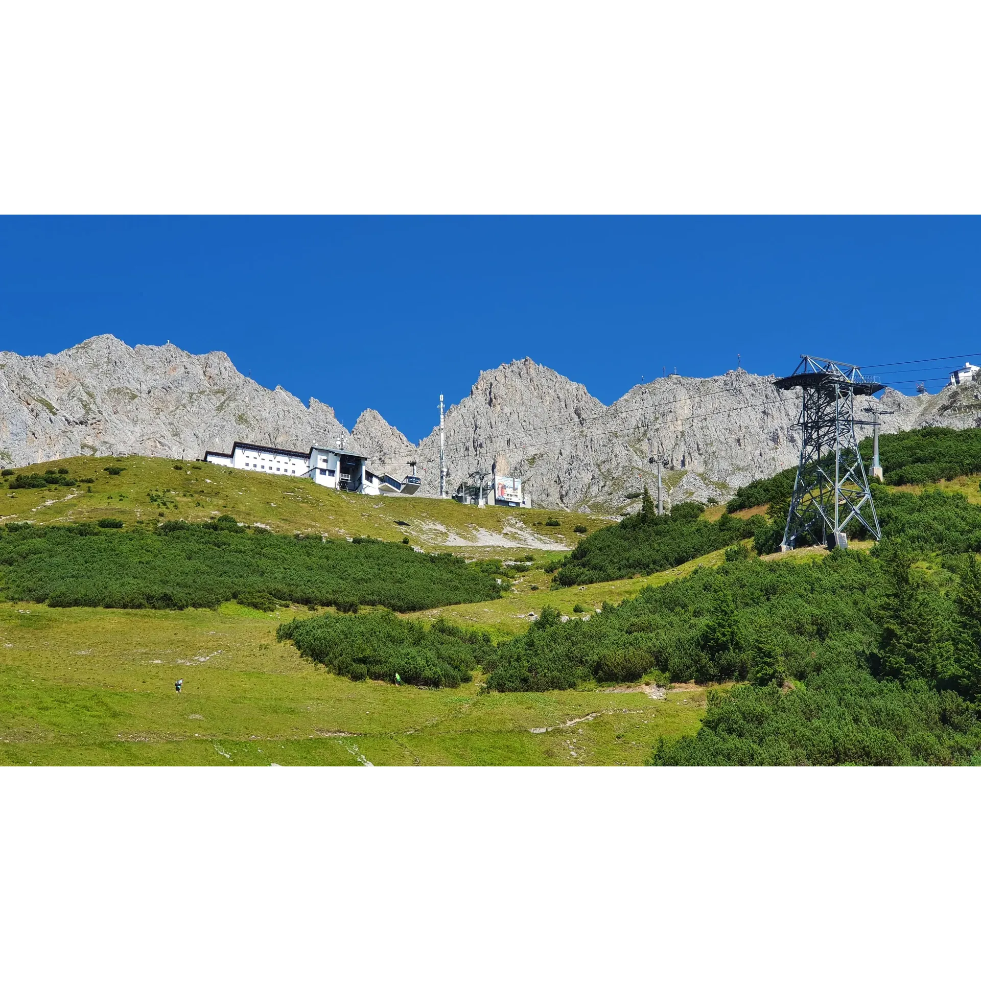 Alpine thoroughfare with frequent switchbacks leading to a summit restaurant & lookout point.