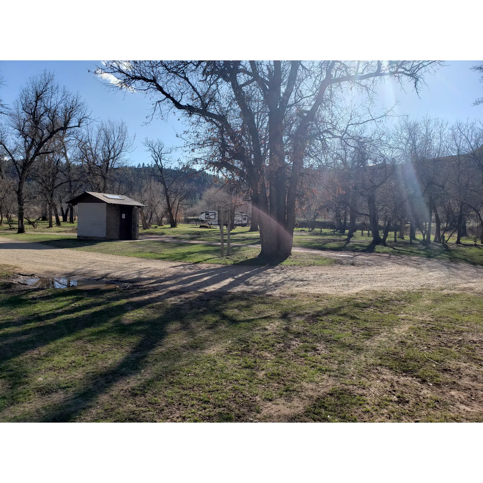 Sand Creek Access Area is a delightful getaway for outdoor enthusiasts seeking a serene, natural setting without the hassle of fees. Offering the allure of boondocking, this site provides the basic amenities one needs to enjoy the great outdoors, such as a pit toilet and a garbage dumpster, ensuring a comfortable stay while being mindful of nature.

Visitors are treated to awe-inspiring, clear starry skies, creating the perfect backdrop for nightly reflections or romantic stargazing. Nature's presence is abundant, with local wildlife sightings such as turkeys, and even the occasional friendly cow might saunter by for a greeting. The area is adorned with clear and captivating waters, inviting tranquility and reflection.

Adventure-seekers and nature-lovers alike rave about the Sand Creek swimming hole and the picturesque waterfall adding a tranquil and refreshing touch to the surroundings. The landscape is beautifully maintained, offering a picturesque scene that captivates the senses and promises relaxation.

For those journeying in larger vehicles, the area is navigable with ample parking that eases the process of maneuvering large RVs or buses, with visitors noting the space to be accommodating. And for the adventurists testing out their travel homes, Sand Creek welcomes maiden voyages and serves as the ultimate test ground to plan future travels.

The area is punctuated with a scatter of camping spots along the road, mostly catering to tent camping, but still accessible for travel trailers or larger rigs that wish to connect with nature. While the terrain may require a careful approach for larger vehicles, the stunning scenery and proximity to Sand Creek's charms more than compensate.

Even in its simplicity, Sand Creek Access Area stands as a testament to the beauty of raw, untouched nature, with the added benefit of good cell phone reception for those who wish to remain connected to the outside world. Each visit to this untouched paradise leaves an indelible mark, ensuring that many will return time and again to bask in its natural splendor. Description by ChatGPT.