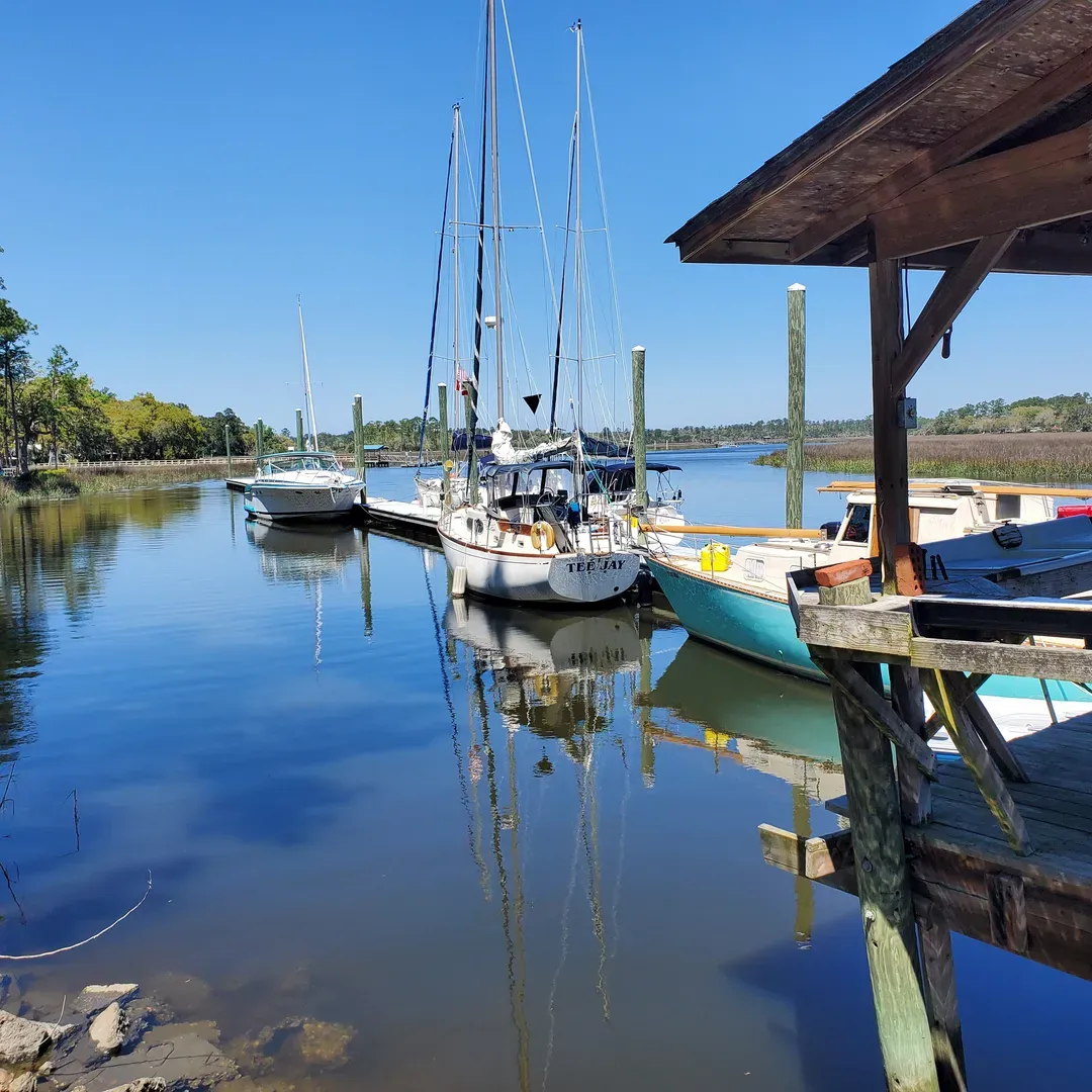 Belle Bluff Island Campground and Marina offers an idyllic retreat for outdoor enthusiasts and peace-seekers alike. Positioned beautifully along the tranquil shores of the White Chimney River and Sapelo Sound, the campground presents stunning waterfront views that serve as a picturesque backdrop for every site. Visitors can select from prime locations that ensure a serene connection with nature, whether they choose to set up their tent along the lush marshland or park their RV with ample room for additional amenities like screen tents.

The grounds boast a variety of waterfront activities. Guests can take full advantage of the long, well-maintained dock extending into the calm waters, perfect for a leisurely day of fishing, crabbing, or setting off by boat to explore the coastal beauty. The Marina is not just a launch point for nautical adventures but also serves as a peaceful spot to witness the breathtaking symphony of sunrise and sunset hues reflecting off the gentle river.

For those seeking a longer-term getaway, Huggin Oaks, its sister camp, offers equally beautiful and spacious lots. The hospitable host ensures a pleasant stay with reasonably priced arrangements, making both campgrounds a must-try recommendation for travelers.

Further accentuating the appeal of Belle Bluff Campground and Marina is their exceptional customer service. With a dedication to hospitality that extends beyond conventional hours, the owner’s willingness to accommodate late arrivals showcases a level of care that resonates with visitors. Accessibility and ease are hallmarked by the ability to make online reservations at any time, creating a smooth and welcoming experience even for those arriving unexpectedly.

The enchantment of Belle Bluff Island is matched by its affordability, making it an accessible paradise for campers and RVers. With well-kept facilities, ample space to spread out, and untouched natural surroundings, visitors find themselves returning time and again. Affectionately commended by guests who have fallen in love with this peaceful sanctuary, Belle Bluff has established itself as a favored stopover or destination for travelers passing through or seeking a tranquil haven away from the city’s hustle. It's a place where the beauty of nature, the joy of waterfront living, and the warmth of genuine hospitality converge to create unforgettable experiences. Description by ChatGPT.