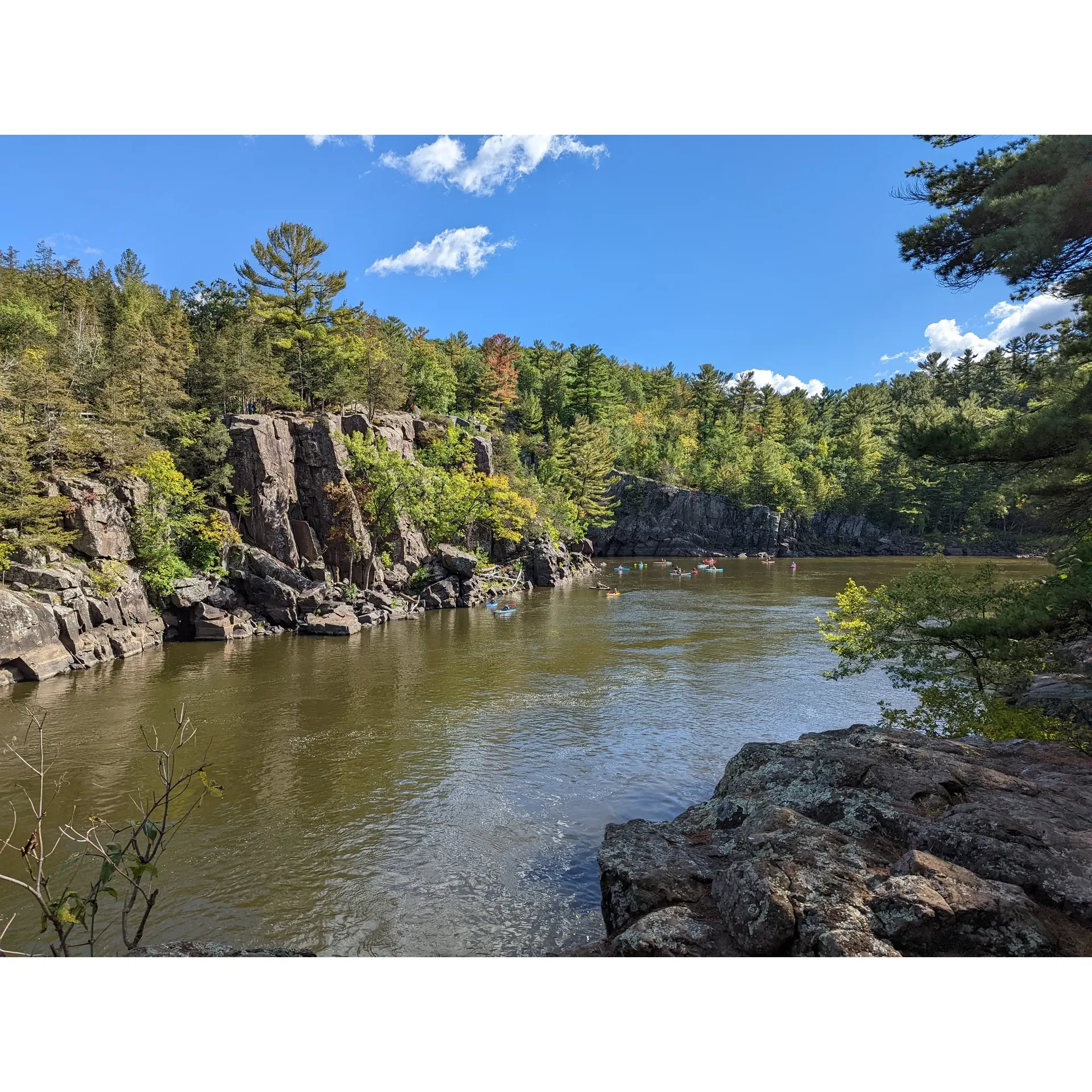 Occupying a prime location near the Twin Cities, Interstate State Park offers a bounty of outdoor adventures set against the serene backdrop of the distinguished St. Croix River. This compact gem of a park beguiles visitors with a rich tapestry of landscapes, from the stunning cliff-top vistas to the lush valleys brimming with seasonal flora. Nature enthusiasts revel in the well-maintained trails, where each step unveils breathtaking scenes and a chance to traverse the realms of ancient geology manifest in the park's world-renowned glacial potholes. 

Springtime cascades a floral spectacle along the trails, while autumn coats the valley in a warm palette of colors, creating an enchantingly picturesque environment for hikers, photographers, and nature lovers. With the charming River Trail offering enticing views and a moderately challenging terrain, hikers often find themselves immersed in the area’s natural beauty.

For those with a nautical inclination, the park’s proximity to the crystalline St. Croix River invites kayakers and canoeists to glide through tranquil waters or embark on a peaceful excursion boat tour, opening up a different vantage point of the park’s scenic beauty. The spirit of adventure escalates for thrill-seekers as the park serves as a popular climbing destination, offering a vertical playground for both novice and skilled rock climbers.

Visitors seeking an extended escape can take advantage of the park's delightful small campground, which provides a harmonious balance of community and privacy. Each site is thoughtfully arranged to ensure a comfortable stay while fostering a sense of seclusion. For those looking to socialize or seeking shelter on rainy days, the park offers a convivial game room.

Social areas by the water present the ideal locale for picnic enthusiasts or groups to gather, unwind, and enjoy the park’s tranquil ambiance. Indeed, the spirit of the park encourages a warm communal atmosphere where shared smiles and genial encounters enhance the visitor experience.

Interstate State Park is not merely a patch of preserved nature; it is a cradle of year-round recreation and tranquility that beckons to all who seek the splendor of the great outdoors within a stone's throw of urban convenience. Whether seeking a rugged outdoor adventure or a peaceful respite from daily life, guests leave with fond memories and a longing to return. Description by ChatGPT.