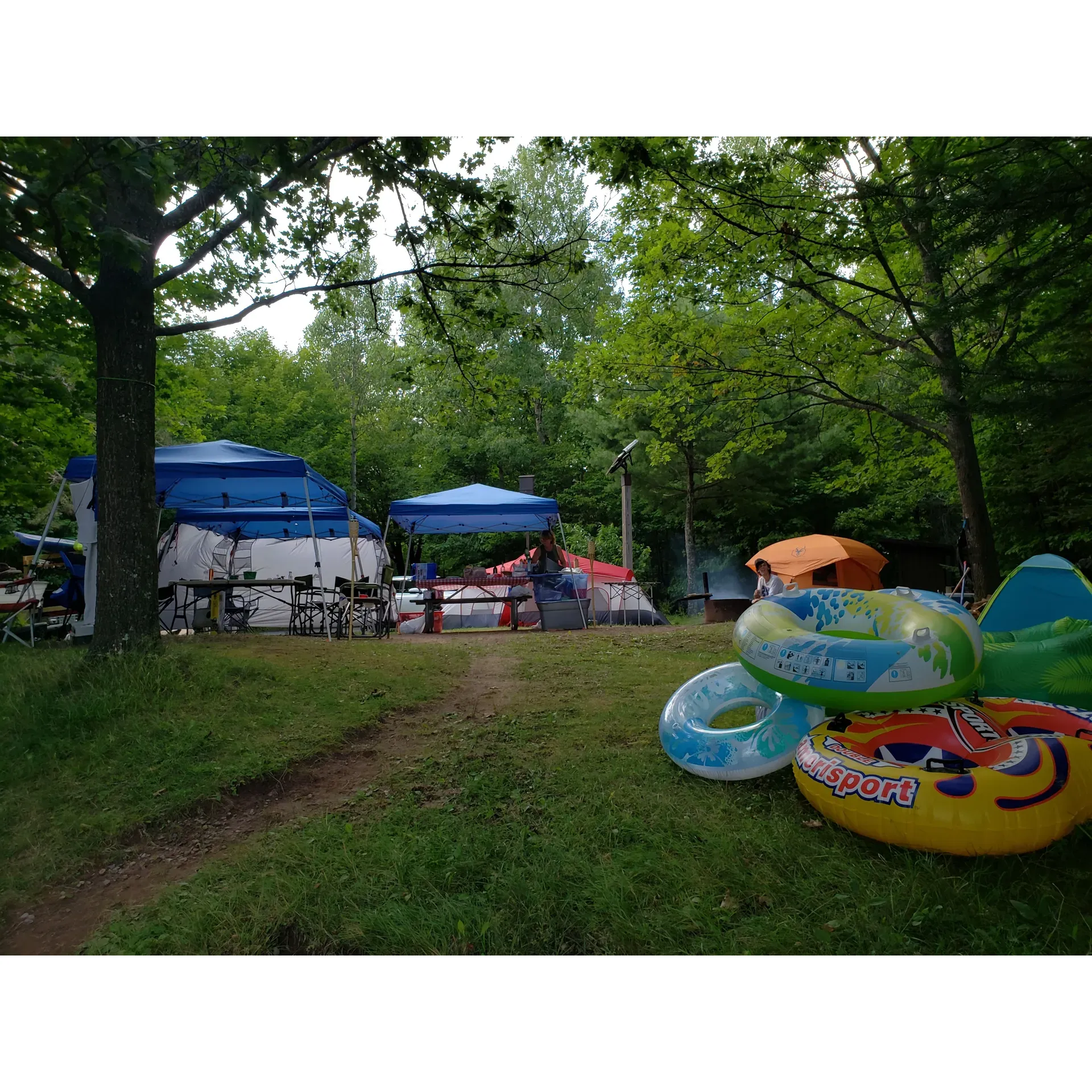 East Twin Lake Campground offers an idyllic retreat for families and nature enthusiasts alike. This serene destination provides guests with the unique appeal of lakefront camping, where the gentle lapping of the lake's waters creates a tranquil backdrop just feet from their campsite. With an array of simple amenities that cater to a rustic outdoor experience, including pit toilets, drinking water, picnic tables, and fire rings, campers can comfortably settle into the natural surroundings.

The campground's well-maintained grounds, including clean vault toilet buildings and accessible water from a solar well, ensure a pleasant and hassle-free stay. The friendly onsite host, praised for their dedication and knowledge of the area, is eager to offer great suggestions and insight into the campground's operation, enhancing visitors' overall experience.

Each campsite promises ample space and privacy, courtesy of the vegetation between sites, creating a sense of seclusion even when the campground is bustling. Several sites are strategically positioned to facilitate group gatherings, making the campground an excellent location for family reunions and group events. Additionally, one walk-in site boasts spacious lake frontage, offering a more secluded option for those seeking solitude.

The lake itself is inviting for swimmers, with its sandy shores progressively giving way to silt, and the water depth increasing steadily for a comfortable swim. Although algae may sometimes be present, it poses little inconvenience and is easily washable. East Twin Lake Campground also offers an opportunity to observe the enchanting turtle nesting in mid-June, adding to the rich natural experience.

With its stunning views and remote charm yet easy access to local towns, the campground is perfect for a range of outdoor activities, including bike camping and water sports in the summer. Guests fondly remember their stays, noting the balance between the region's bustling activity and the ease with which wind currents can manage to keep the fly populations at bay.

East Twin Lake Campground is an excellent recommendation for those seeking a picturesque camping experience, where natural beauty, well-kept facilities, and a friendly community come together to create the perfect outdoor retreat. Whether for a solo adventure, a romantic getaway, or a joyous family trip, visitors are drawn back year after to year to indulge in this delightful haven. Description by ChatGPT.