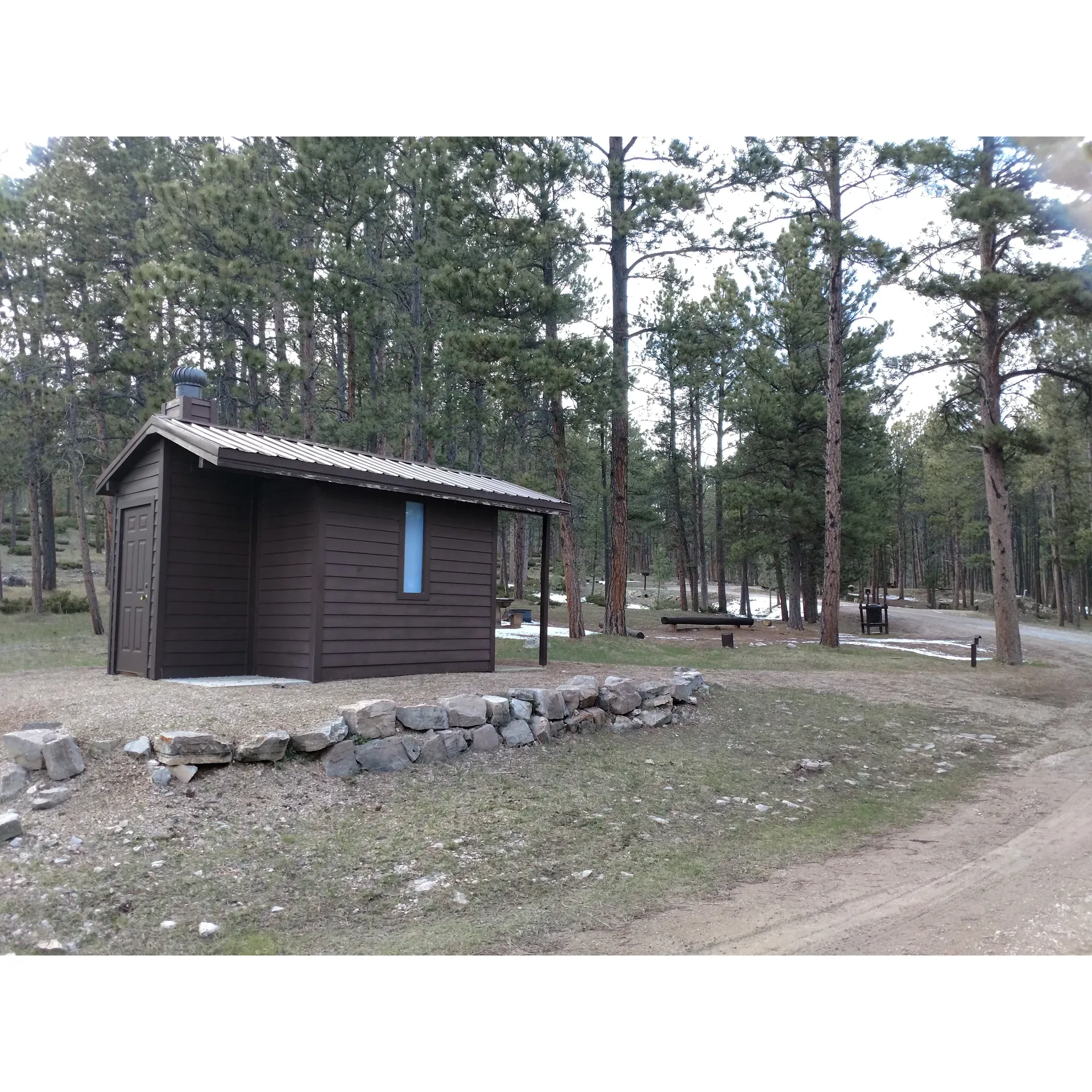 Reuter Campground in Sundance, Wyoming, is a serene State Park offering an unspoiled outdoor experience and the perfect gateway to the iconic Devils Tower National Monument, just a 30-minute drive away. Visitors to Reuter Campground can relish in expansive, well-spaced lots providing privacy and a sense of solitude amidst the wilderness. The sites accommodate a range of setups, with specific spots like lot #20 being ideal for larger RVs, allowing for a comfortable back-in with sufficient space for additional vehicles like touring motorcycles.

Surrounded by thriving wildlife and picturesque scenery, campers can enjoy an authentic camping experience complemented by hard-packed gravel lots that blend seamlessly into the natural landscape. Each site comes equipped with a robust concrete picnic table and a well-maintained fire ring, inviting guests to indulge in cozy campfires under the starry sky. For convenience, there are water spigots nearby to replenish water supplies as needed.

While the campground is a peaceful retreat, it does not leave guests disconnected from the world. Cell service across several carriers, including T-Mobile, Verizon, and Cricket, is reported to be strong, ensuring that visitors can stay connected if they wish, using their own phones and hotpots.

Reuter Campground is pet-friendly, welcoming furry companions for a nominal additional fee, allowing the whole family to enjoy the adventure. The park's management is known for their helpfulness, contributing to a welcoming and assisted arrival experience.

The nearby town, just a 30-minute drive, makes it convenient for guests to access groceries and other essentials. Moreover, the Warren Peak lookout tower is right up the road, offering another local attraction to explore.

For those looking for day trips or adventures close by, Reuter Camp. The area remains relatively peaceful even during peak season, providing an intimate outdoor ambiance.

Affordability is also a highlight at Reuter Campground, presenting one of the best value stays in the region while not compromising on the quality of the experience. With its prime location, inviting atmosphere, and the charm of Wyoming's natural beauty, Reiter Campground stands out as an excellent choice for outdoor enthusiasts and those looking to explore the wonders of Devils Tower and beyond. Description by ChatGPT.