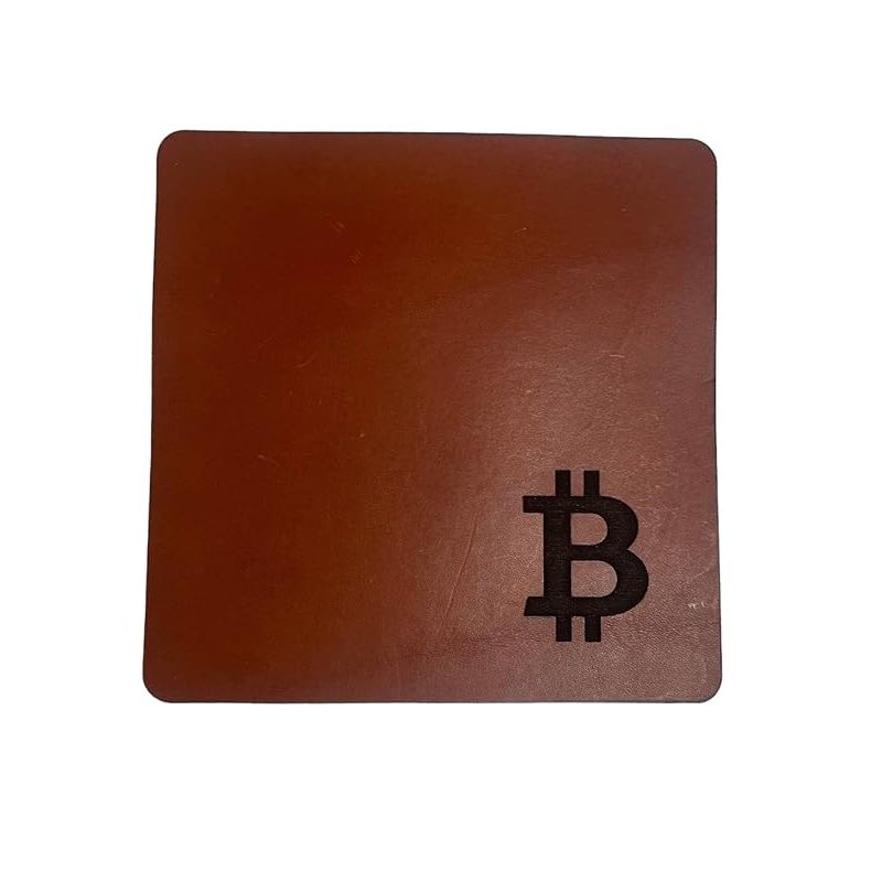 This Premium Leather Bitcoin Mouse Pad is a high-quality desk accessory perfect for cryptocurrency enthusiasts. Hand-crafted in the United States, this mouse pad features a sleek design with an engraved BTC (Bitcoin) logo, making it a stylish and functional addition to any workspace.