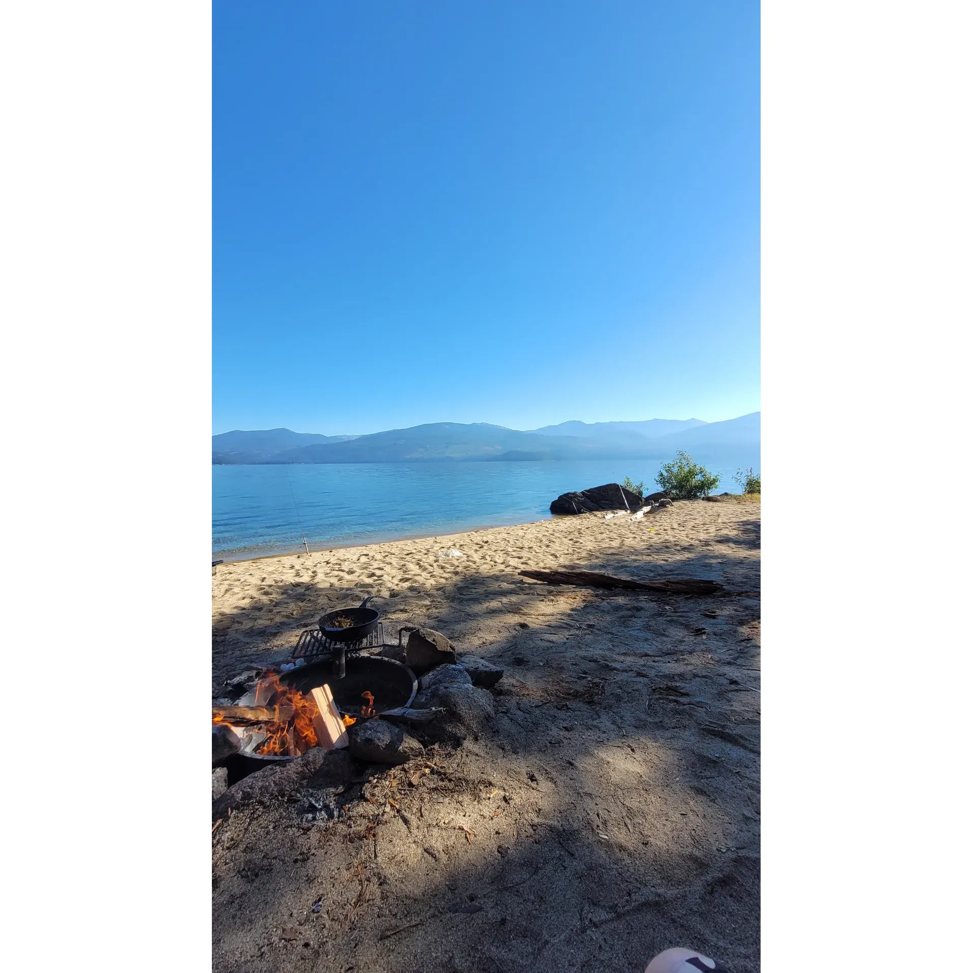 Rocky Point Campground, a serene paradise located on Kalispell Island, offers a unique retreat for outdoor enthusiasts looking for tranquility and natural beauty. This watercraft-accessible haven boasts warm and sunny mornings perfect for early risers to bask in the day's first light, while providing cooling shade for restful evenings under the stars.

The campground's charm is magnified by its proximity to scenic walking trails inviting adventurers to explore the island's picturesque landscapes. Each campsite offers spacious, leveled areas ideal for pitching tents, ensuring a comfortable and relaxing stay. The sites are well-appointed with new picnic tables and a cleverly designed fire ring with a hinge grill, perfect for cooking up a hearty outdoor meal while enjoying the serene backdrop.

Cleanliness and privacy are hallmarks of Rocky Point Campground, with well-maintained amenities and a pristine outhouse adding to the comfort of your outdoor experience. Boating into one of the campsites is not just a journey but an escape from the bustling mainland, leading you to a secluded spot with breathtaking views that span the horizon.

Visitors will delight in the exclusivity that comes from the boat-in only policy, adding a layer of peace and quiet to their stay. The campground's allure is evident in the uniform beauty across Kalispell Island, allowing guests to choose their ideal vista, whether it be the glistening waters or the lush, forested surroundings. With nature's grandeur at every turn, Rocky Point Campground provides an idyllic setting for reconnecting with nature and creating cherished memories. Description by ChatGPT.