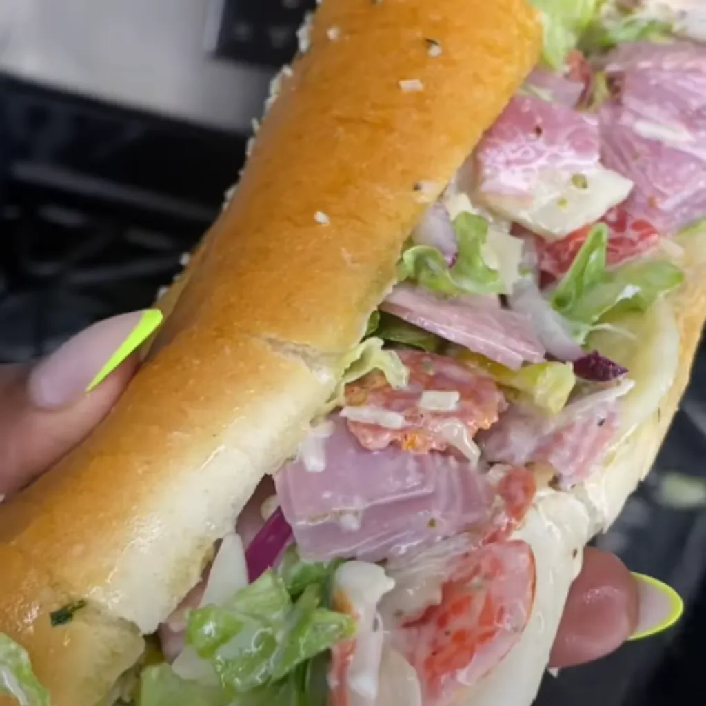 Indulge in an Italian-inspired culinary delight with this mouthwatering Italian Grinder Sandwich. Packed with fresh crisp vegetables, a rich variety of savory meats, and a creamy zesty dressing, this sandwich offers a symphony of flavors and textures.