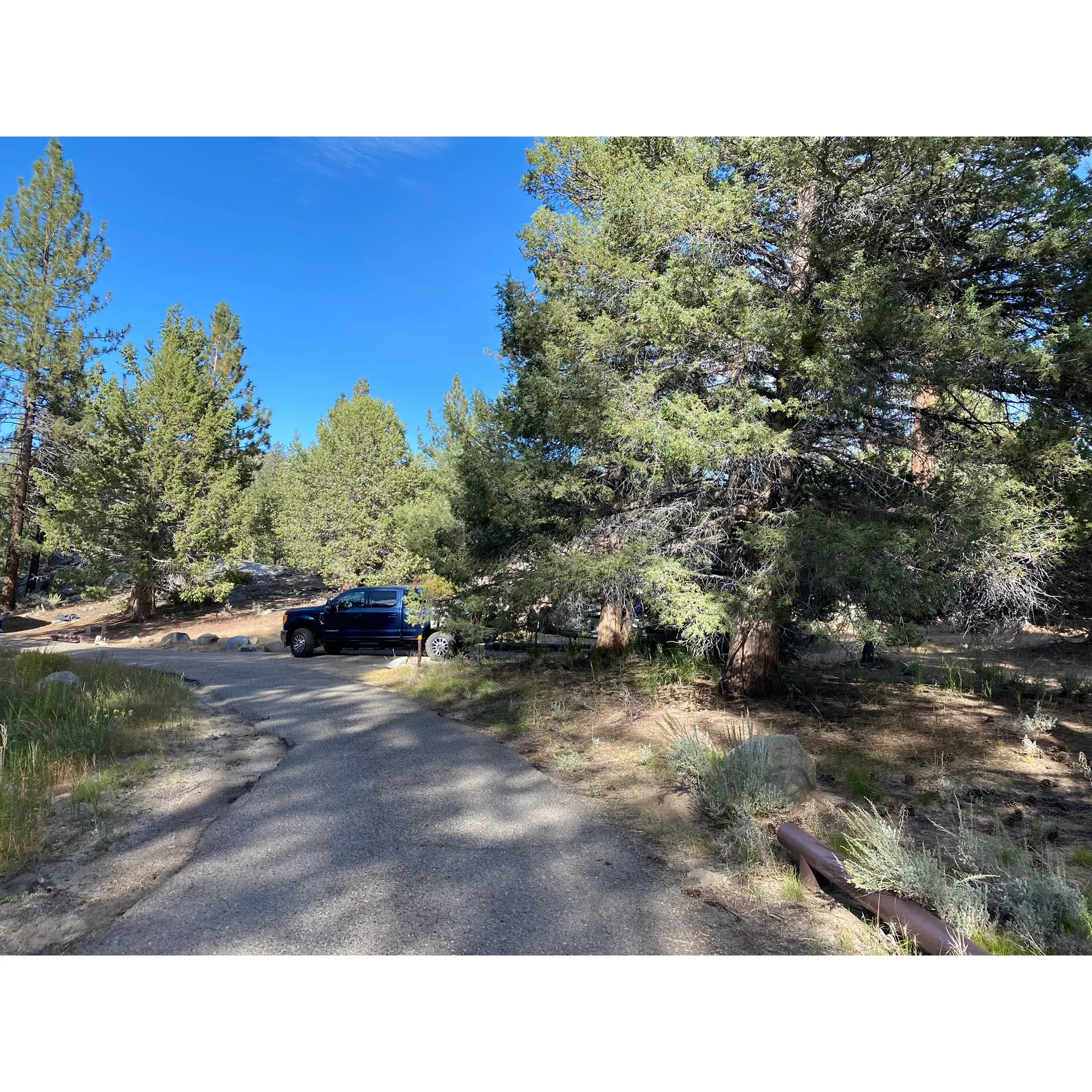 Discover the tranquil charm of Fish Creek Campground—a serene escape where the splendor of nature envelops you. This picturesque haven, perched at a refreshing 7400 feet elevation, promises respite from the summer heat and an idyllical setting for outdoor enthusiasts and adventure seekers alike.

Seasoned fishers will revel in the opportunity to cast a line for golden trout in the clear, flowing creek, while explorers will be enchanted by the extensive network of trails that traverse the majestic landscape. Trails that unfurl from your campsite lead to refreshing meadows and streams, making every day a new adventure.

Campsite 35 is a particularly spacious gem, offering an expansive area for parking up to three vehicles, and ample space to set up tents, hammocks, and cooking equipment. It also features a direct trail to the creek, where you can immerse yourself in nature or simply cool down in the water. The pet-friendly atmosphere means that your furry friends can partake in the joy and freedom that Fish Creek Campground offers.

The grounds are meticulously maintained, with clean vault toilets and a regular supply of essential amenities. Though water spigots are available, visitors come prepared with their own drinking water supplies, ensuring a comfortable and worry-free stay.

One cannot help but appreciate the thoughtful balance between the raw, rustic elements of traditional camping and the necessary comforts. Each paved campsite is equipped with a fire ring and a picnic table, serving as the perfect backdrop for a night of stories and laughter under the stars or simply relaxing to the natural symphony of the wind rustling through the trees.

Despite its remote and peaceful setting, devoid of cell service, the allure of the Fish Creek Campground lies in its offering of a sanctuary where one can truly disconnect and be present. With warm days easing into crisp nights, the campground provides a year-round refuge for motorcycle trail enthusiasts, with Red Sticker Bikes welcome throughout the year.

For a modest fee of $17 per night, with a minimal additional charge for extra vehicles, visitors can enjoy a first-come, first-served slice of paradise. Whether seeking solitude, a fishing haven, a nexus of challenging trails, or simply a place to recharge and reconnect with nature, Fish Creek Campground is a delightful choice that promises a memorable and rejuvenating outdoor experience. Description by ChatGPT.