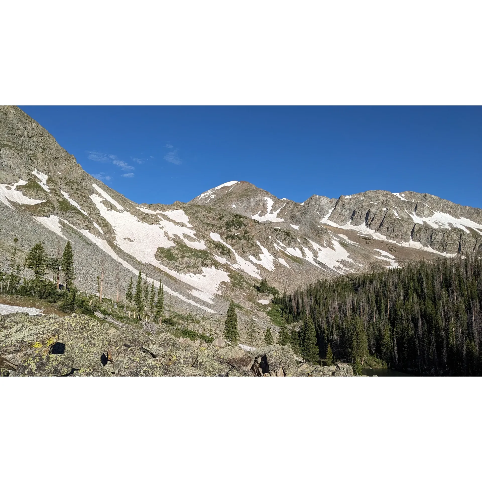 This picturesque campsite offers an authentic wilderness retreat, perfect for nature enthusiasts and outdoor adventurers alike. With its proximity to crystal-clear fresh water, it promises a serene setting for campers to unwind or prepare for a trek to the majestic Lake of the Clouds. The location benefits from being well-protected from the mountain winds while basking in the warmth of the first rays of morning sunlight, ensuring a cheerful start to the day.

Visitors will delight in the opportunity to encounter the local wildlife, as the site is frequented by an array of small mammals, including a resident yellow-bellied marmot known for its friendly disposition towards humans. This adds a unique charm to the camping experience, offering up-close encounters with nature.

Campers are advised to apply smart wilderness food storage practices, such as using a suspension line, to maintain harmony with the natural inhabitants and safeguard their supplies, ensuring a comfortable and responsible stay. The campsite's lush wood mulch provides a comfortable ground surface, although outdoor enthusiasts are encouraged to come prepared with repellent for a carefree outdoor adventure.

In essence, this campsite promises a delightful escape into the wilderness, offering shelter, scenery, and a touch of wildlife interaction, all contributing to a memorable outdoor experience. Description by ChatGPT.