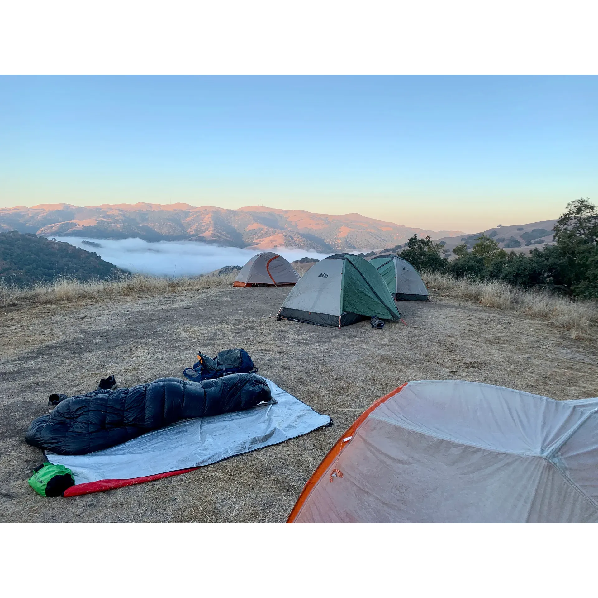 Stars Rest Backpack Camp is an idyllic sanctuary for anyone seeking an outdoor adventure wrapped in tranquility. Ideally suited for groups like Scout Troops, the camp offers sprawling sites dispersed generously across the property, ensuring privacy and an immersive experience in nature. Guests are often captivated by the breathtaking panoramic vistas of the valley that can be enjoyed from the comfort of their campsite, adding a picturesque backdrop to their stay.

Camping at Stars Pro Backpack Camp is more than just an overnight outing; it's a rewarding journey through the great outdoors. Hikers can look forward to a satisfyingly challenging trek of approximately 3.25 miles, including an 800-foot elevation gain, to reach their destination. The path leads through the scenic marvels of Little Yosemite, with well-marked trails guiding visitors to their secluded retreat.

Once at the campsite, the reward for your effort unfolds as a beautiful flat area equipped with accommodations for tent setup. A separate lower level is designated for dining preparations, featuring tables and a convenient food prep area, allowing campers to enjoy their meals amidst nature.

Enthusiasts of the great outdoors will appreciate the camp's sustainability initiatives; the absence of waste receptacles emphasizes the importance of leaving no trace, encouraging visitors to pack out what they bring in. Furthermore, although there is a modest distance to potable water and restroom facilities, the camp maintains a high standard of cleanliness, ensuring a comfortable and unspoiled environment for its guests.

Natural encounters are a highlight at Stars Rest, where the distant serenades of coyotes may grace the night air, and the occasional scent of a wandering skunk reminds you that you are in the heart of wildlife territory. However, with thoughtful campsite design, including recommendations for food storage, visitors can rest assured that their provisions remain secure.

Stars Rest Backpack Camp offers adventurers an opportunity to disconnect from the mundane and reconnect with nature. From the cozy seclusion of your camping spot to the sweeping views and the raw beauty of the ascent, this backpack camp is a cherished escape into the wilderness that's ideal for those who respect and relish the great outdoors. Description by ChatGPT.