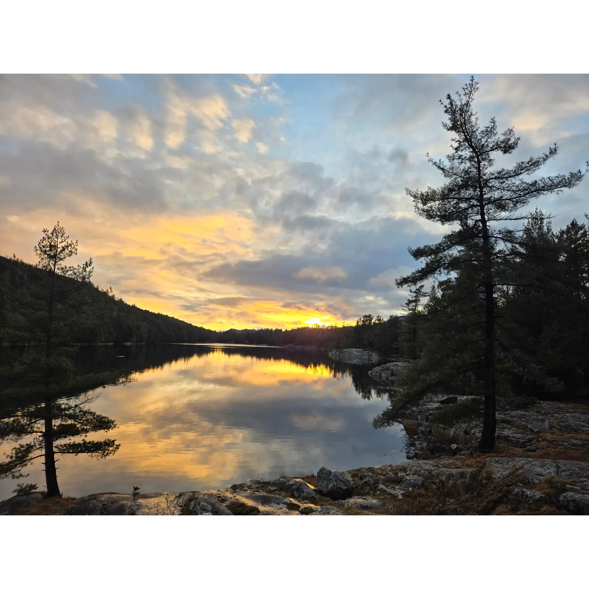 Backcountry Campsite #H5 at Cave Lake is a popular camping spot located in the Municipality of Killarney, Ontario. This remote campsite offers visitors a serene and peaceful setting surrounded by the pristine wilderness of Killarney Provincial Park. The campsite is only accessible by hiking or paddling, providing a true backcountry experience for outdoor enthusiasts.

Cave Lake campsite #H5 is equipped with a fire pit, picnic table, and bear-proof food locker to ensure a safe and comfortable camping experience. The site is located near the picturesque Cave Lake, offering stunning views of the water and surrounding forests. Visitors can enjoy activities such as hiking, fishing, canoeing, and wildlife spotting in this secluded and beautiful area.

Campers are required to obtain a backcountry camping permit in advance to secure a spot at Cave Lake campsite #H5. It is recommended to plan ahead and pack all necessary gear and supplies, as facilities are limited in this remote location. Visitors can immerse themselves in the natural beauty of Killarney Provincial Park at this stunning backcountry campsite. Description by ChatGPT.