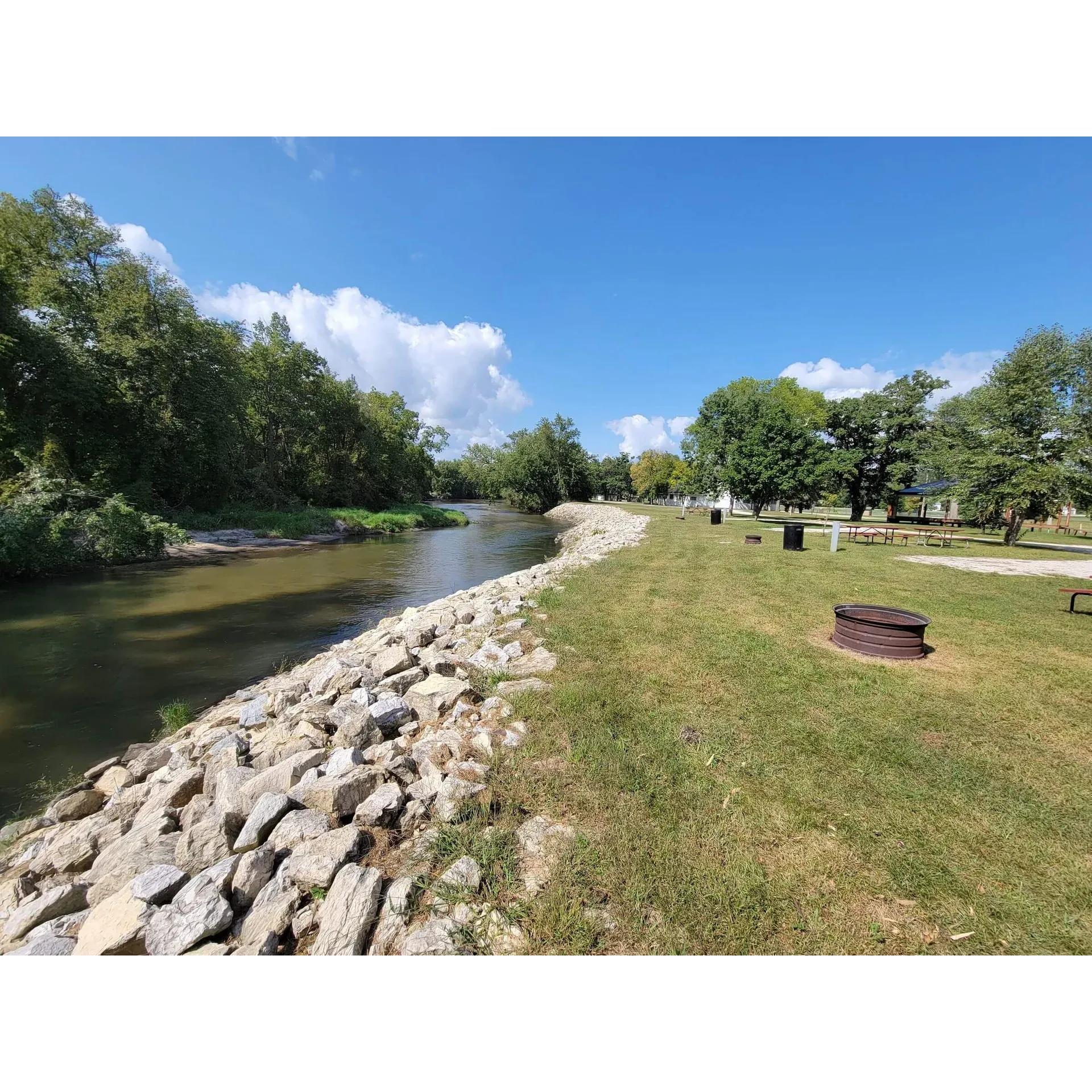 Riverside Park Campground provides a picturesque outdoor retreat that's perfect for both adventure seekers and families looking to create lasting memories. This serene destination offers visitors spacious camping spots with the tranquil backdrop of a gently flowing river, ideal for an array of activities such as fishing, canoeing, and leisurely riverside walks.

Renowned for its well-maintained grounds and facilities, each campsite is equipped with the necessary amenities to ensure a comfortable and hassle-free experience. The friendly and dedicated staff at Riverside Park Campground are committed to excellence, going above and beyond to accommodate the needs of their guests, fostering a welcoming and supportive community atmosphere.

The campground showcases a variety of recreational facilities designed to entertain all ages. The family-friendly environment is reflected in the playgrounds and community spaces, where children can play and families can gather for barbecues and social events. Guests can enjoy the warmth of community fire pits, perfect for socializing and toasting marshmallows under the stars.

Riverside Park Campground has received glowing reviews for providing a splendid outdoor getaway. With its harmonious blend of natural beauty and exceptional service, it stands out as an idyllic escape for campers who appreciate a rejuvenating outdoor experience with a personal touch. Whether you're looking for adventure or tranquility, this campground is poised to deliver an unforgettable stay. Description by ChatGPT.