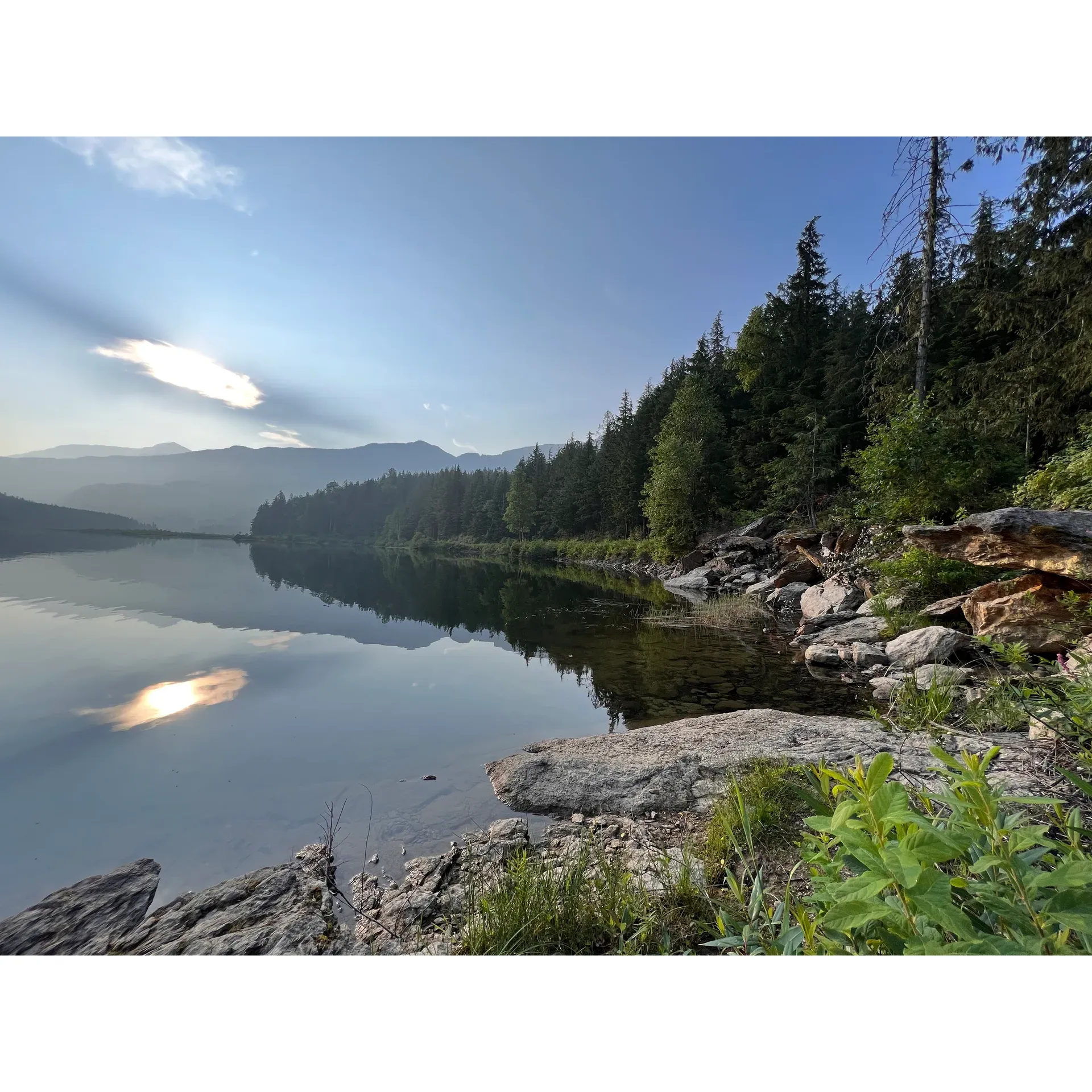 Set against the serene backdrop of a tranquil lake, Wap Lake West Recreation Site offers a unique and intimate escape into the splendor of nature. This charming recreation site is a hidden gem for campers who yearn for a slice of solitude amidst the great outdoors. Boasting a limited number of camping spots, visitors are often delighted to find themselves in a personal haven with ample space to relish the surroundings.

Embraced by pristine waters, the recreation site is a haven for those passionate about paddle boarding, kayaking, and other gentle water activities. The lake's calm surface is an invitation to glide peacefully, allowing adventurers to become one with nature. As you immerse yourself in the stillness, the local wildlife sets the scene for an enchanting experience. Resident eagles soar gracefully overhead, offering an opportunity for birdwatching, while the industrious beavers provide a fascinating glimpse into the natural world as they go about their activities.

The site's proximity to the road ensures easy access for those looking to escape the urban buzz. Despite the rugged approach, the journey is part of the adventure, leading to a peaceful retreat where the busyness of life fades into the background. Here, the symphony of nature replaces the noise of crowded spaces, capturing the hearts of those in search of a restorative outdoor experience.

Adored for its tranquility and privacy, Wap Lake West Recreation Site is an idyllic spot for personal retreats, offering a connection to nature that is, at once, both intimate and inspiring. Whether you're here to bask in the peaceful ambiance, engage in water sports, or simply enjoy having a scenic setting all to yourself, this cherished site welcomes each visitor with the promise of cherished memories and a rejuvenating stay. Description by ChatGPT.