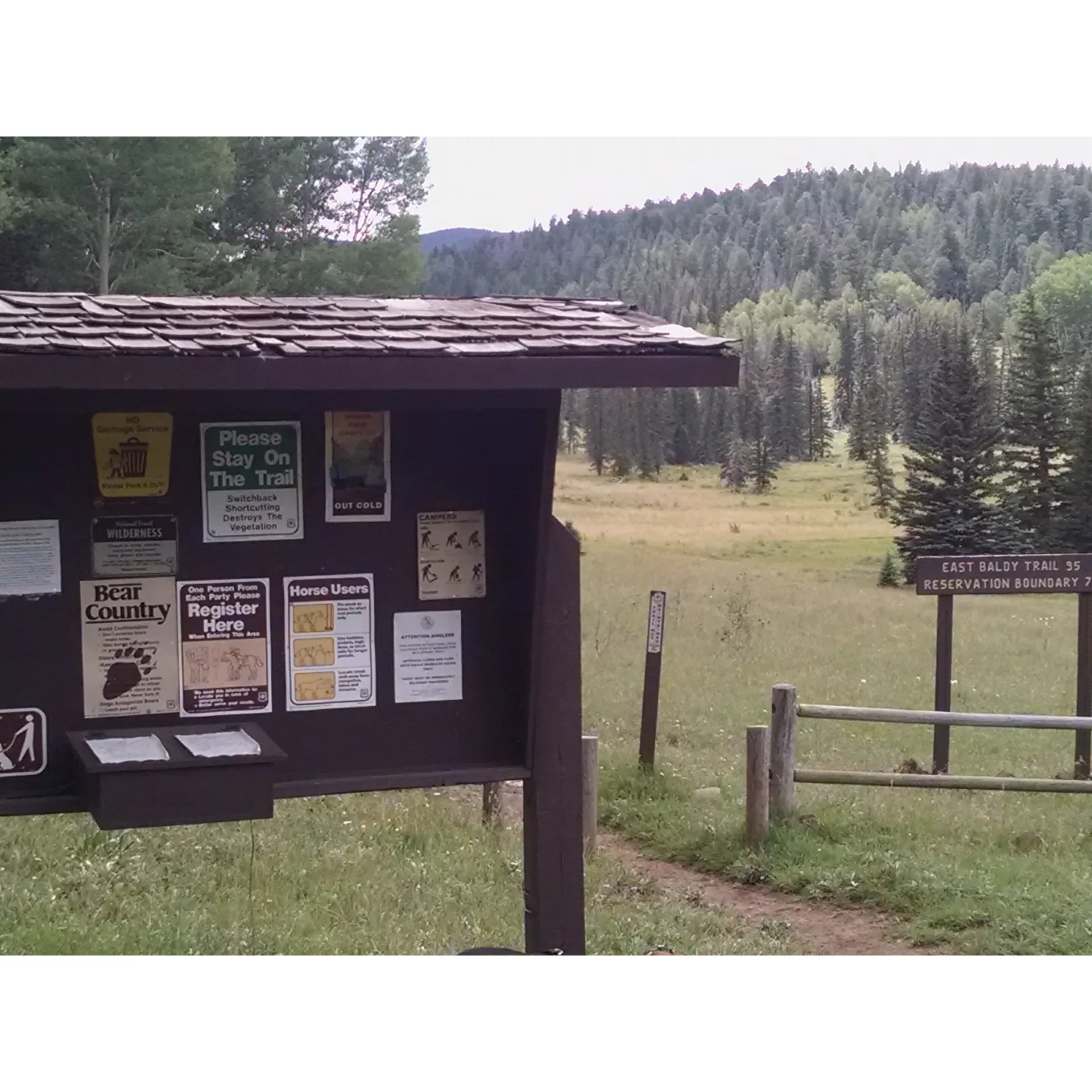 Gabaldon Horse Camp is a serene outdoor retreat that offers a unique combination of equestrian facilities and scenic wilderness. Located in a lush, forested area with spacious horse pens, this camp is a sanctuary for horse enthusiasts and nature lovers alike. Majestic trees tower above, providing a canopy of green, while remnants of historical logging in the form of massive, moss-covered stumps add a touch of time-standing-still to the surroundings.

Ideal for horse camping, the camp boasts plenty of room to park and set up for an extended stay, with easy access to ensure convenience for all visitors. The wooden corrals are both substantial and easily accessible, ensuring that your equine companions are safe and comfortable during your visit. While on-site water sources are not available, the ample space and well-maintained facilities more than make up for this, as long as visitors remember to bring their own water supplies.

From the camp, adventurers can embark on the East Baldy trailhead leading to Mt. Baldy, where the beauty of the natural landscape unfolds. The trail is particularly enchanting during the fall when the foliage transforms into a tapestry of vibrant colors, though it remains a picturesque escape in the summertime as well. The camp's prime location also offers proximity to Lee Valley, Reservation Lake, and Big Lake, expanding the opportunities for outdoor recreation and stunning vistas.

Clean and well-maintained restrooms are available for both men and women, adding a touch of comfort to the rustic setting. While visitors may feel a nostalgic nod to the region's literary heritage could enhance the camp's charm, the breathtaking views and direct access to the Mt. Baldy 94 trail make Gabaldon Horse Camp a splendid jump-off point for exploring the area.

Even for those who are not horse owners, the camp provides a peaceful spot to relax and immerse in the scenery. The campsite's tranquility and the stables' appeal assure that everyone, including the horses, can revel in the natural splendor that Gabaldon Horse Camp has to offer. It's a perfect destination for those seeking to escape the bustle of daily life and embrace the restorative powers of the great outdoors. Description by ChatGPT.