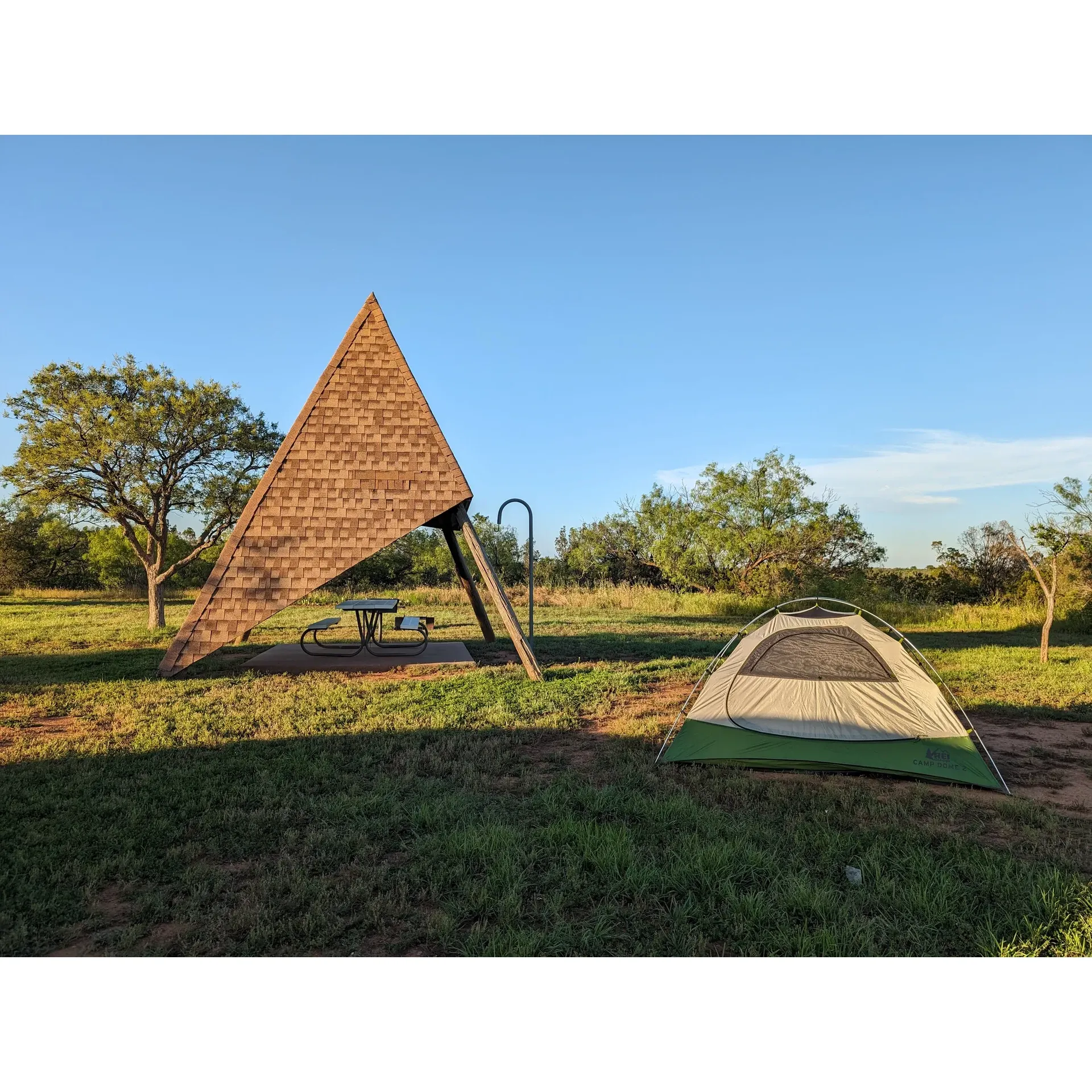 Comanche Campground offers a serene getaway with spacious and well-maintained sites, each offering plenty of room for campers to spread out and relax in the great outdoors. The grounds are meticulously cared for, with regularly mowed grass and clean facilities, ensuring a comfortable stay for all visitors.

Guests can look forward to picturesque evenings under the spectacular night sky, where the stars seem to shine brighter against the campground's open expanse. The nearby lake, while rustic in its natural state, provides a scenic backdrop that compleplies the beauty of the area, offering a sense of tranquility and a perfect setting for contemplation or leisurely activities.

Each site is equipped with convenient back-in spaces, making it easy for campers to settle in. To enhance the outdoor experience, the campground has unique teepee covers over picnic tables, providing welcome shade and adding an interesting aesthetic touch to the site. While the hot sun can be a factor for RVs, these covered areas offer respite for campers during the day.

Wildlife enthusiasts and photography aficionados will find the campground to be a treasure trove of opportunities, especially during migratory seasons when the air is filled with the songs of birds like the vibrant Painted Bunting, and the landscape is adorned with wildflowers.

For added comfort, the campground provides large sites complete with water and electric hookups. The bathhouse is noted for its cleanliness and the convenience of hot showers and flush toilets.

Outdoor adventurers will appreciate the trails that wind through the campground, perfect for exploration and connecting with nature. If seeking quietude, the campground's ambiance is noted for its peacefulness, allowing for restful and tranquil nights.

Overall, Comanche Campground is an inviting destination for those looking to enjoy the great outdoors in a spacious and well-cared-for setting, complete with the amenities that make camping a delight. Whether stopping for an overnight stay or seeking an extended retreat into nature's embrace, visitors can look forward to a memorable and enjoyable experience. Description by ChatGPT.