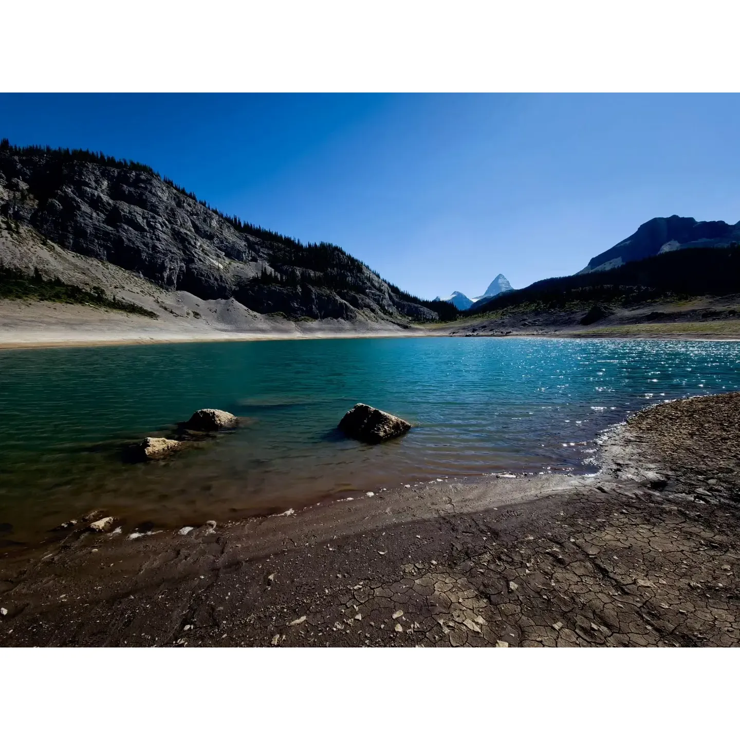 Og Lake Campground emerges as an idyllic retreat for nature enthusiasts seeking an escape amidst the great outdoors. The strategic location of the campground makes it a perfect waypoint for explorers journeying from Sunshine Meadows, especially when the day breaks fresh and early. The site boasts of a harmonious marriage between convenience and the serene wilderness, offering visitors a practical yet memorable outdoor experience.

Travelers can anticipate basic amenities that cater to their essential needs, allowing them to immerse themselves fully in the raw beauty of their surroundings without the distraction of urban luxuries. The pristine waters of the nearby clean lake provide a tranquil setting for visitors to relax and rejuvenate, whether it's a refreshing dip or a peaceful moment on its banks. 

One of the most captivating features of Og Lake Campground is the magnificent view of Mount Assiniboine. Standing majestic in the distance, the mountain provides a breathtaking backdrop that draws the eye and fills the spirit with awe. The vista is a photographer's dream and a nature lover's paradise, elevating the camping experience to new heights.

Whether as a restful pause on a longer trek or a destination in its own right, Og Lake Campground offers an opportunity for campers to forge unforgettable memories in the embrace of the wilderness. Its combination of necessary comforts, natural splendor, and awe-inspiring scenery makes it a cherished spot for those seeking to connect with nature. Description by ChatGPT.