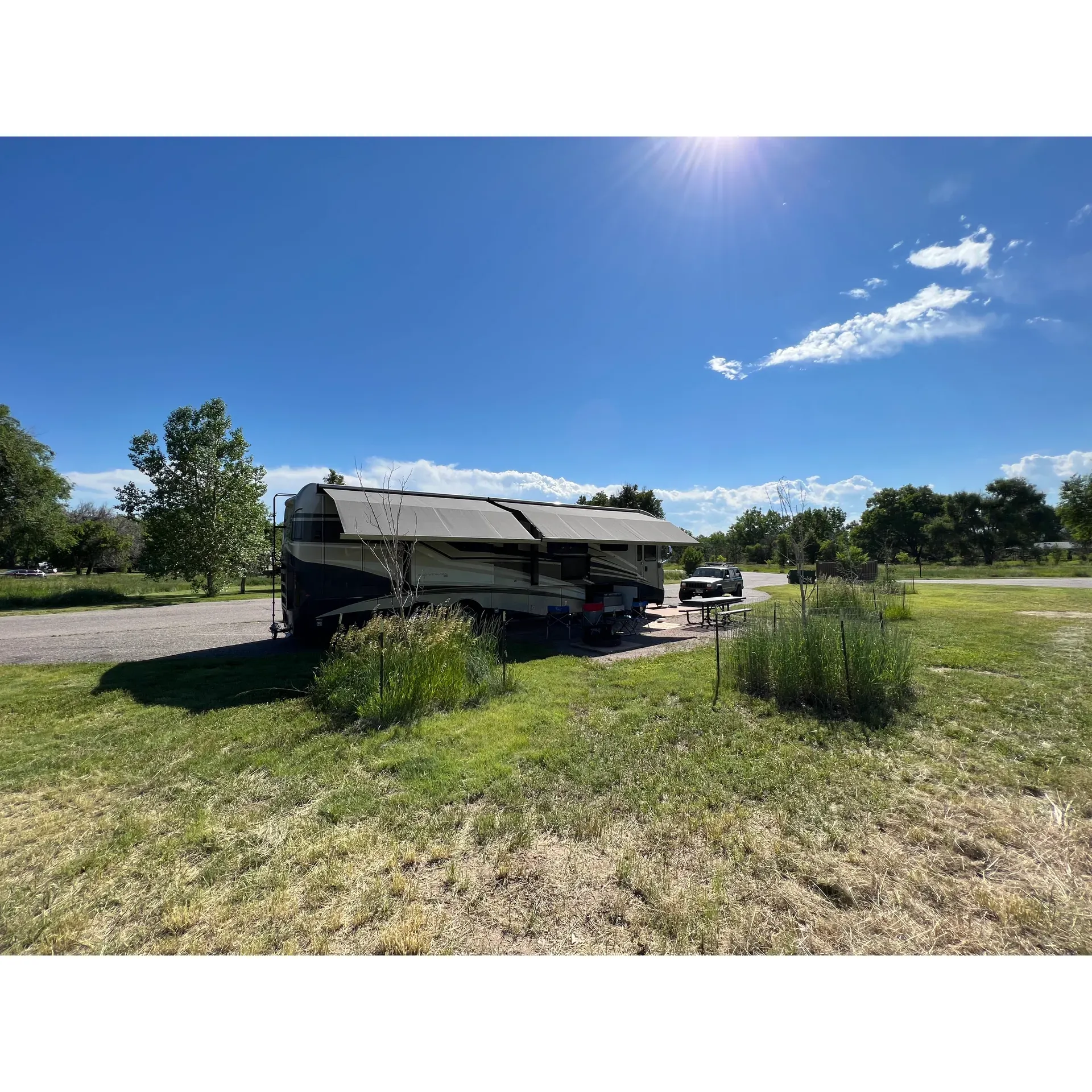 Cherry Creek State Park in Aurora, CO, is an exceptional outdoor escape offering a cornucopia of recreational activities that cater to families and friends alike. This picturesque park is the perfect venue for a wide array of outdoor pursuits, including serene fishing, exhilarating water sports, and delightful picnicking with options to grill your own feast. Visitors are encouraged to unwind along the sandy shores, immerse themselves in nature by camping, or bask in the sun's warmth while taking in the scenic views.

With sprawling spaces designed for children and families, the park is a hub of entertainment complete with playground amenities, and refreshment stands that serve a variety of drinks and food. An extensive area is dedicated to sports enthusiasts who enjoy spiking a volleyball on the beach courts or engaging in friendly soccer or football matches.

Boating enthusiasts can revel in the pleasures of navigating the large reservoir, while nature lovers can observe the local wildlife in their natural habitat. The park's grounds boast an accommodating infrastructure for recreational vehicles, complete with RV sites with full hookups. Well-sought-after loops like the Cottonwood Grove offer ample shade from mature trees, and the Gold Rush loop presents an open prairie setting.

Moreover, the on-site marina adds a touch of tropical ambiance with sandy areas and a beachside bar, enhancing the park's variety and appeal. Commitments made by the staff to maintain this outdoor haven ensure a pleasant and tidy camping experience.

For those seeking the convenience of proximity to urban centers, Cherry Creek State Park serves as a perfect blend of outdoor leisure and easy access to the city. Whether planning a weekend getaway or a longer stay, the park provides an idyllic and versatile Colorado experience that caters to a diversity of desires and interests, ensuring memorable times for all who visit. Description by ChatGPT.