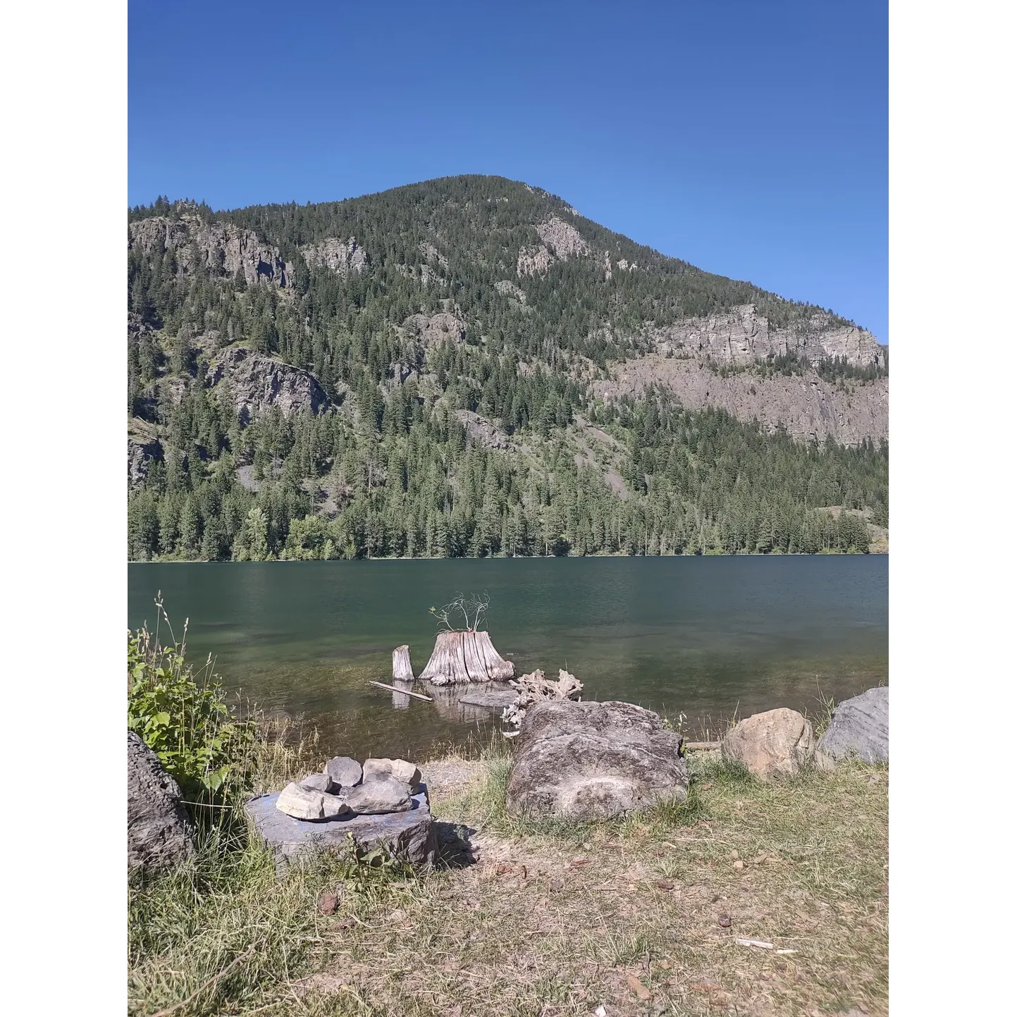 McDonald Lake Campground is a serene destination perfect for outdoor enthusiasts looking to enjoy a day by a picturesque lake. Surrounded by stunning landscapes, the campground is a haven for kayakers, swimmers, and families who can often be seen delighting in the crystal-clear waters with their kids and furry friends. While the lakeshore is rocky, it adds to the rustic charm of the area, providing a natural setting for visitors to spread out and enjoy the beauty.

Wildlife watchers are in for a treat as the local fauna, including the occasional bear sighting, adds a touch of wilderness adventure to the experience. The campground is easily accessible during the summer months, requiring no special vehicles to navigate the roads, ensuring a hassle-free journey to the heart of nature.

The lake is a hub of activity, offering vibrant scenery and ample opportunities for recreation. It's essential for visitors to obtain the appropriate permits to fully enjoy the amenities, including fishing, as the site is well-patrolled by wardens ensuring everyone can have a safe and enjoyable experience.

Although the number of overnight camping sites is limited, this exclusivity ensures a more intimate connection with nature, making it an ideal spot for day-trippers seeking tranquility amid beautiful surroundings. McDonald Lake Campground is truly a slice of paradise, offering striking views and a peaceful atmosphere, making it a cherished getaway for making lasting memories. Description by ChatGPT.