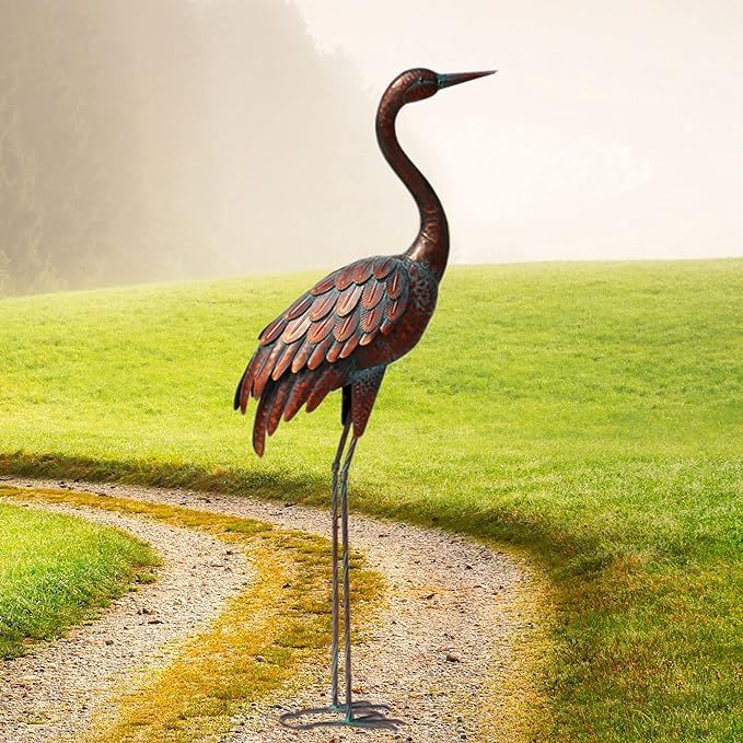 Chisheen Outdoor Garden Crane Statues and Sculptures are metal yard art pieces that add an elegant touch to any garden or outdoor space. These statues feature two majestic crane birds standing gracefully, with intricate details and a lifelike finish.