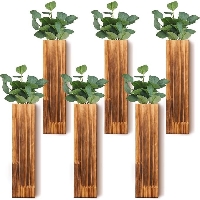 The 6 Pack Wood Wall Planter is a set of six wooden hanging planters designed for dried flowers, artificial greenery, or hydroponic plants. These pocket vases can be hung on a wall to add a touch of farmhouse charm to any indoor space, such as a home or office.