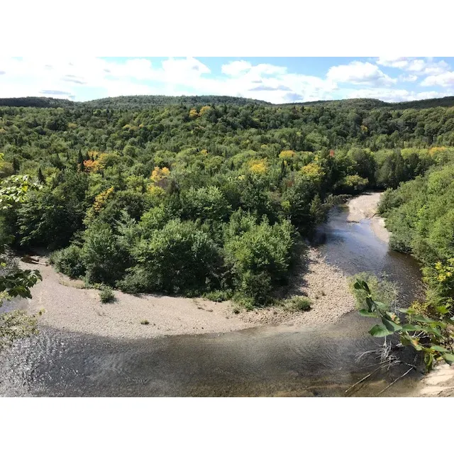 Portneuf Natural Regional Park serves as a tranquil oasis where stunning scenery and majestic riverbanks invite visitors for an array of outdoor activities. Starting from the accessible secteur des gorges chalet, guests can embark on an easy walk alongside the serenity of the river, taking in the soothing sights and sounds of nature. Conveniently located at 423 rue principale in Saint-Alban, the park offers ample parking, ensuring a seamless transition from the hustle and bustle of city life to the peaceful embrace of the great outdoors.

Entry to the park is reasonably priced, providing access for up to five adults per vehicle, making it an economical choice for group outings. Upon arrival, guests are welcomed by friendly and knowledgeable reception staff, ready to offer insights and information to enhance the experience of the park's visitors.

Seasonal changes adorn the park with different natural attires, beckoning visitors to return and witness the transformation of the landscape throughout the year. The park boasts a plethora of trails, each leading to its own unique natural wonders, including a charming waterfall cascading over a dam and a picturesque creek that serves as a delightful stop for travelers journeying between Montreal and Quebec City.

Those seeking adventurous activities will not be disappointed, as the park offers a chance to explore the river itself, with easily spotted ice formations visible within a short distance from the entrance. A visit in the winter season unveils a captivating snowy paradise, perfect for creating memorable family moments. In addition to hiking, the park provides facilities for waterborne adventures like kayaking, paddleboarding, and canoeing, as well as cozy accommodations such as tents, chalets, and lodges for guests who wish to extend their stay and soak in the tranquil environment for a couple of days.

Ideal for both families and individuals, including the four-legged members, Portneuf Natural Regional Park is a versatile destination that caters to various interests and age groups. With the convenience of online reservation and the accessibility of multiple trails, some that gracefully trace the river's edge, this regional park is a testament to the simple joys of being immersed in nature's embrace – an exceptional retreat not far from Quebec's urban centers. Description by ChatGPT.