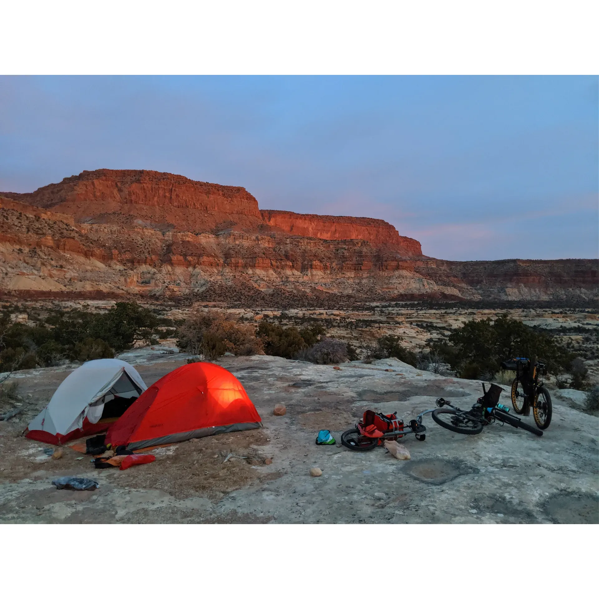 Teapot Rock Camp presents a serene haven for campers seeking the ultimate blend of adventure and tranquility. Occupying a prime location at the entrance of the uncharted Teapot Canyon, this campsite is a favorite among those who appreciate the beauty of the rugged outdoors. Offering a dramatic vantage point overlooking the magnificent landscapes, visitors can revel in breathtaking views that promise to elevate the camping experience.

For explorists inspired by the call of the wild, Teapot Rock Camp serves as an excellent gateway to several days of exploration within this isolated terra firma. The area invites introspective wandering and provides a unique opportunity for solitude, allowing one to deeply connect with nature's untouched splendor.

Camping enthusiasts will appreciate the unspoiled environment and are encouraged to maintain its cleanliness as a shared responsibility to keep the site pristine for fellow adventurers. Teapot Rock Camp is especially favorable for those with roof-top tents, providing an even more remarkable way to spend the night atop a natural rock platform under a blanket of stars.

Embracing the rugged essence of the terrain, the campsite offers a distinctive outdoors experience. With the wilderness as your backdrop, Teapot Rock Camp is a remarkable destination for those looking to escape the everyday and immerse themselves in a raw, undisturbed setting full of natural intrigue. Description by ChatGPT.