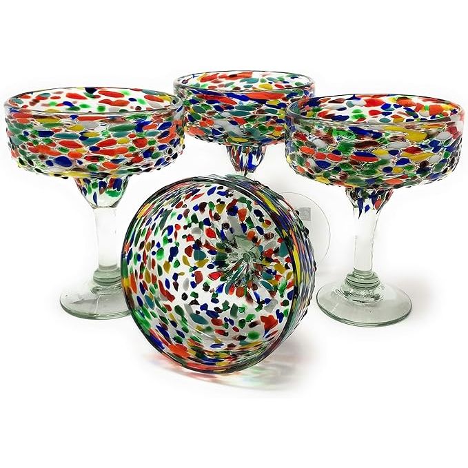 Dos Sueños Mexican Hand Blown Glass offers a set of four hand-blown margarita glasses featuring a stunning confetti rock design. Each glass has a capacity of 16 ounces, making them perfect for serving your favorite margarita or cocktail.