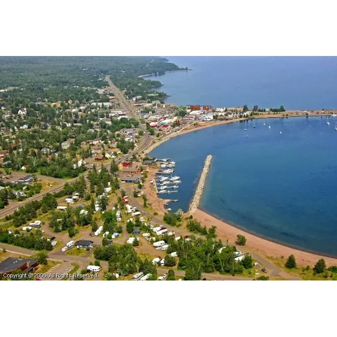 Grand Marais Campground & Marina offers an exceptional outdoor experience with its prime location along the picturesque beachfront and proximity to the charming downtown area. Offering spacious sites that cater to both the privacy-seeking and community-loving camper, this destination provides a variety of settings from secluded spots to more open communal areas, each accompanied by convenient amenities such as picnic tables and fire pits.

Visitors consistently rave about the immaculate condition of the facilities, highlighting the large, clean bathrooms and the particularly impressive shower pressure that serves as a refreshing treat for campers. The campground boasts an array of trails suited to different levels of adventure - from the more leisurely paths to challenging hikes that reward with breathtaking views.

Families find the campground ideal for creating lasting memories, with its accessibility allowing for easy trips into town without the need for constant driving. Even during colder times, the warmth and excitement of the campground experience isn't dampened. Additionally, accessibility is enhanced by thoughtful features like portable potties conveniently situated next to certain sites.

Stargazers revel in the opportunity to stroll to the nearby beach, which opens up to the night sky's splendor, undisturbed by city lights. It's a favorite feature that keeps visitors returning year after year.

The friendly and helpful staff contributes to the welcoming atmosphere, ensuring that guests feel at home and have everything they need for a pleasant stay. Moreover, the campground's competitive pricing is appreciated by those seeking value, making it a top choice even when state parks reach capacity.

With full hookups available, campers can enjoy the comforts of home while embracing the serene environment. While enjoying the overall good vibe of the campground, guests can gaze out at the stunning views of Lake Superior or make the easy walk to soak in the natural beauty that surrounds this favored camping spot. Description by ChatGPT.