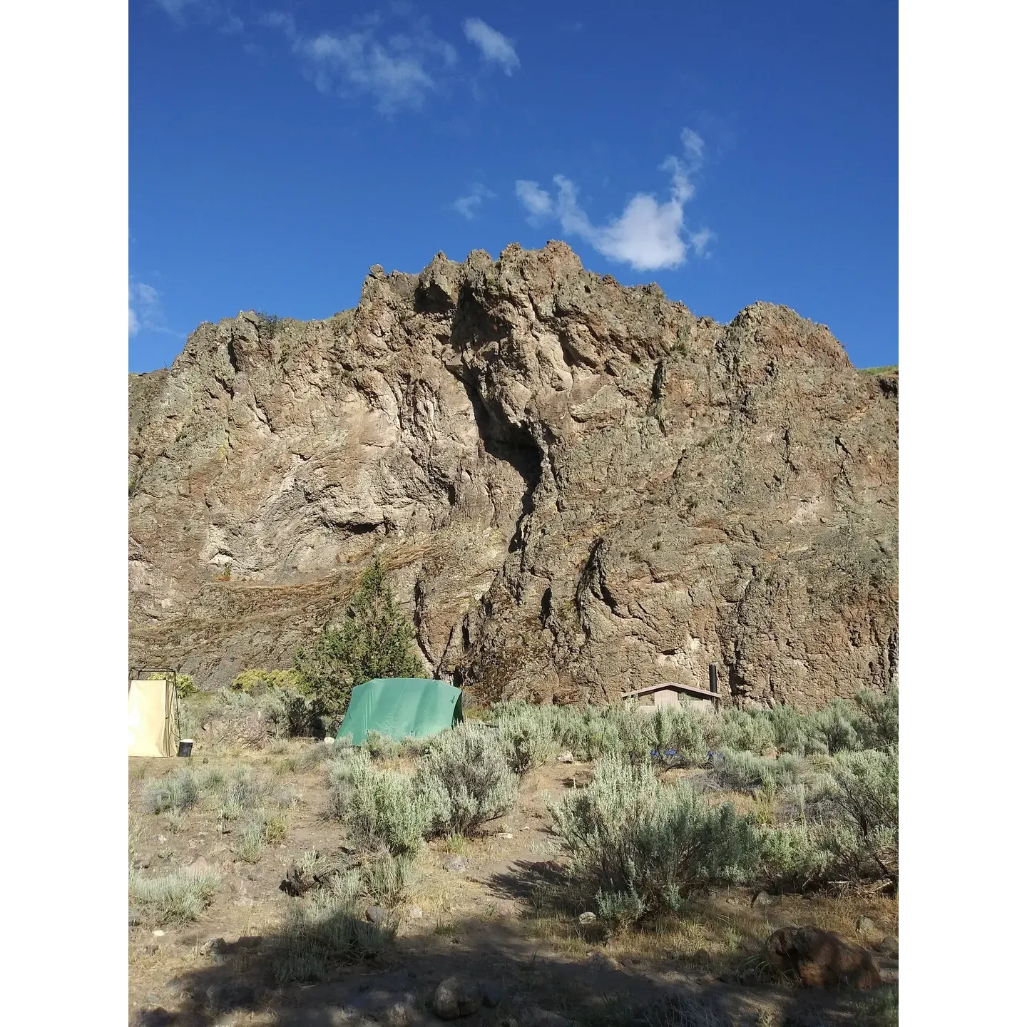 Four Chutes Campsite, a well-loved haven for outdoor enthusiasts, offers an idyllic setting along the scenic Deschutes River. Its prime location is perfect for those looking to indulge in a tranquil riverside escape right before concluding their river journey. The campsite's thoughtful orientation allows for a delightful reprieve from the early morning light, providing guests with a cooler, more comfortable start to their day, particularly during warmer seasons. 

As the sun arcs across the sky, visitors can bask in the warmth of the afternoon rays before it dips behind the surrounding hills, creating a naturally temperate environment to relax in. The gentle rustling of leaves and the soft quacking of ducks enhance the serene ambience, allowing campers to immerse themselves in the picturesque beauty of the area.

With its convenient proximity to the river, Four Chutes Campsite is the perfect spot for spending a couple of restful days surrounded by nature's splendor. Whether you're looking to relax by the water's edge or seeking a peaceful rest stop before the final leg of your river adventure, this campsite promises a memorable stay amidst the great outdoors. Description by ChatGPT.