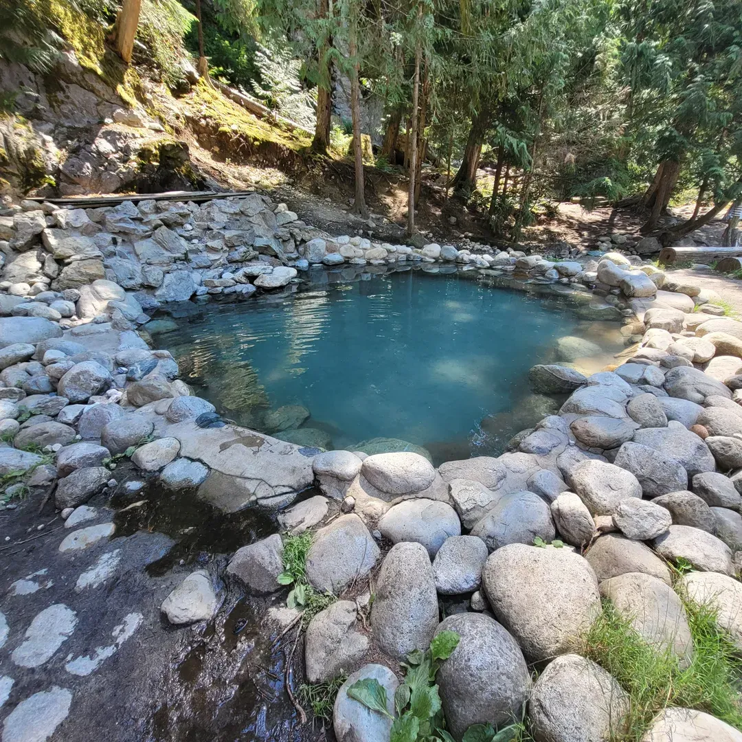 Experience the serenity and rejuvenation of Halfway Hot Springs, a blissful retreat that guarantees an invigorating connection with nature. Located within a picturesque setting, visitors often praise the well-maintained trail that meanders through breathtaking scenery, guiding adventurers from the parking area down to the riverside. Although the descent is considered quite steep, it rewards with an unparalleled sense of accomplishment and the anticipation of the thermal delights to come.

Halfway Hot Springs offers a delightful selection of thermal pools, with temperatures ranging from steaming hot to pleasantly warm, ensuring something suitable for every preference. The pools, described as large and deep, present an idyllic sanctuary for relaxation, able to accommodate numerous guests without feeling crowded. With their varying temperatures, they promise a refreshing dip for everyone, while the mesmerizing blend of hot spring water and the cool river creates a unique and thrilling experience.

Visitors commend the convenience and cleanliness of the onsite changing area, which is positioned to allow quick and comfortable transitions from adventurous hiker to serene soaker. Picnic benches scattered throughout the area offer welcoming spots for visitors to enjoy a meal amidst nature's grandeur, contributing to the overall appeal of the location.

The atmosphere at Halfway Hot Springs is noted for its friendliness and laid-back, family-friendly vibe. This natural attraction is celebrated for its unspoiled and authentic character, where the beauty of the environment remains untouched, and the experience feels genuine.

Accessibility to this rugged paradise is part of the adventure, with the final gravel approach adding to the sense of seclusion and escape from the everyday world. While the terrain may be unrefined, the getaway it leads to is unequivocally rewarding. Accessible by foot and with ample opportunity for hiking enthusiasts to utilize their gear, Halfway Hot Springs is recognized as a precious natural gem.

Best of all, this enchanting experience is offered free of charge, inviting visitors to indulge in nature’s therapy without financial concern. Halfway Hot's reputation is one of admiration and enthusiasm, often leaving guests eager to return and keen to recommend this hotspot for a truly unique and invigorating hot springs experience. Description by ChatGPT.